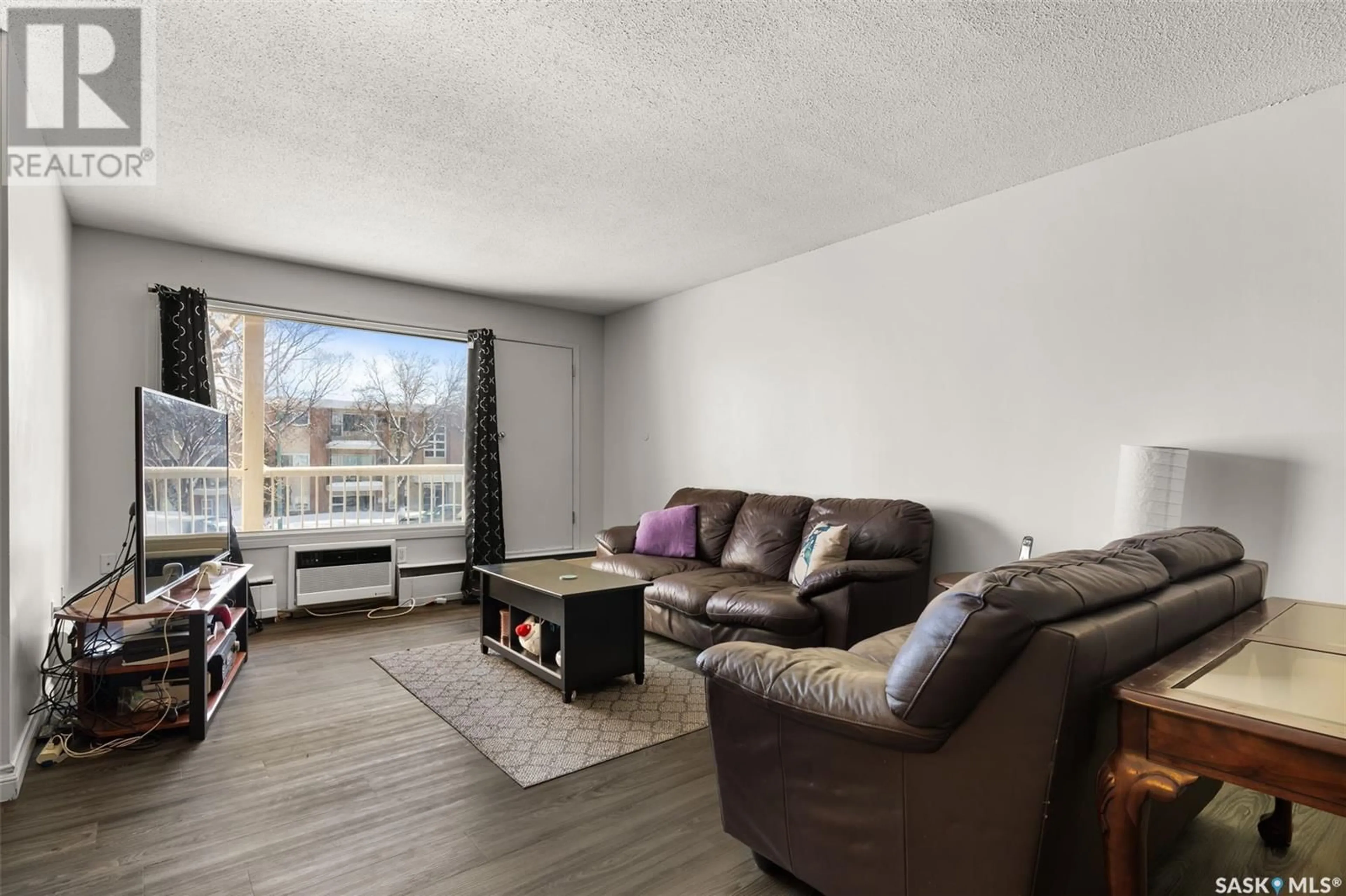 Living room with furniture, wood/laminate floor for 12 1811 8TH AVENUE N, Regina Saskatchewan S4R0G5