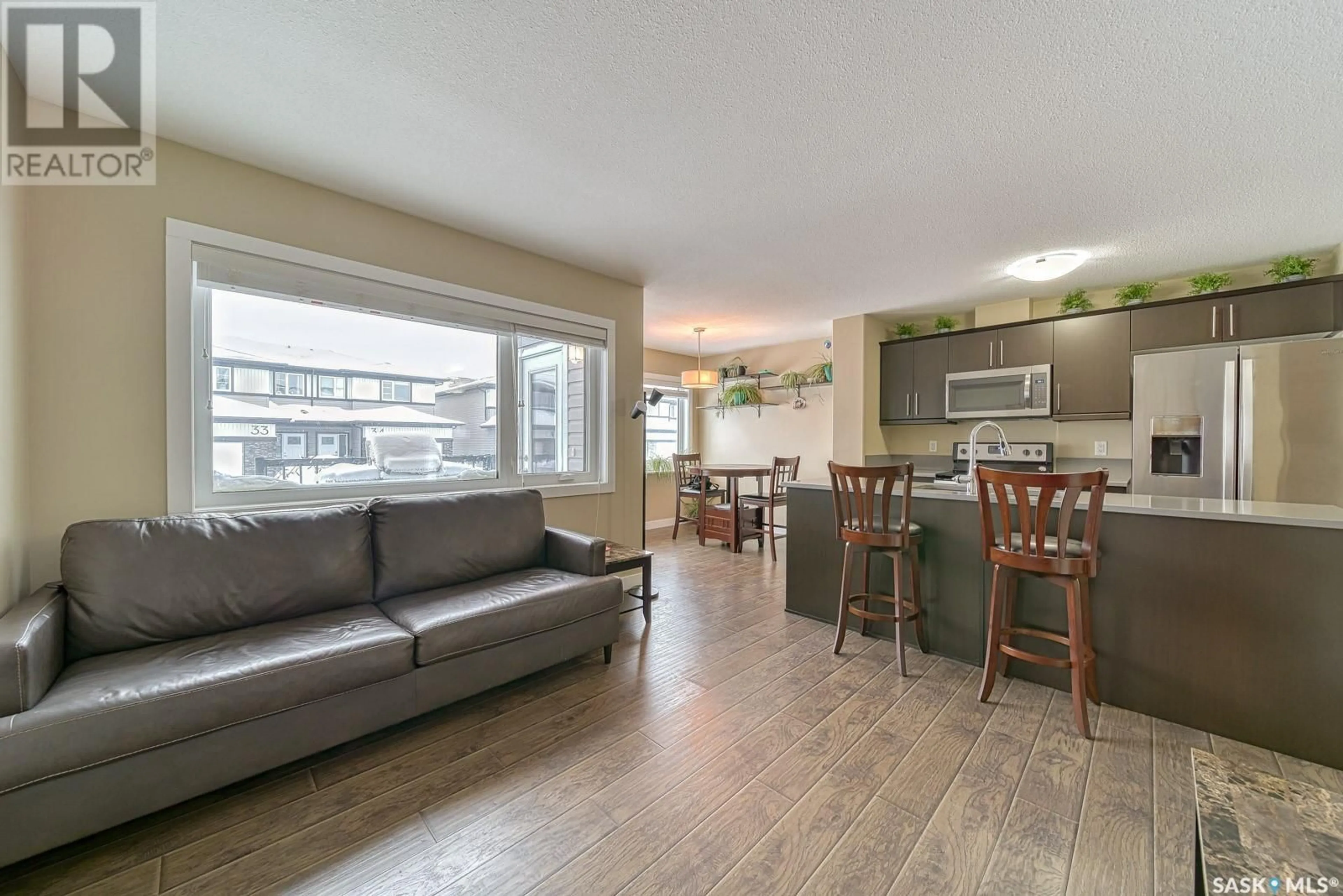 Open concept kitchen, wood/laminate floor for 46 5301 Beacon DRIVE, Regina Saskatchewan S4W0R6