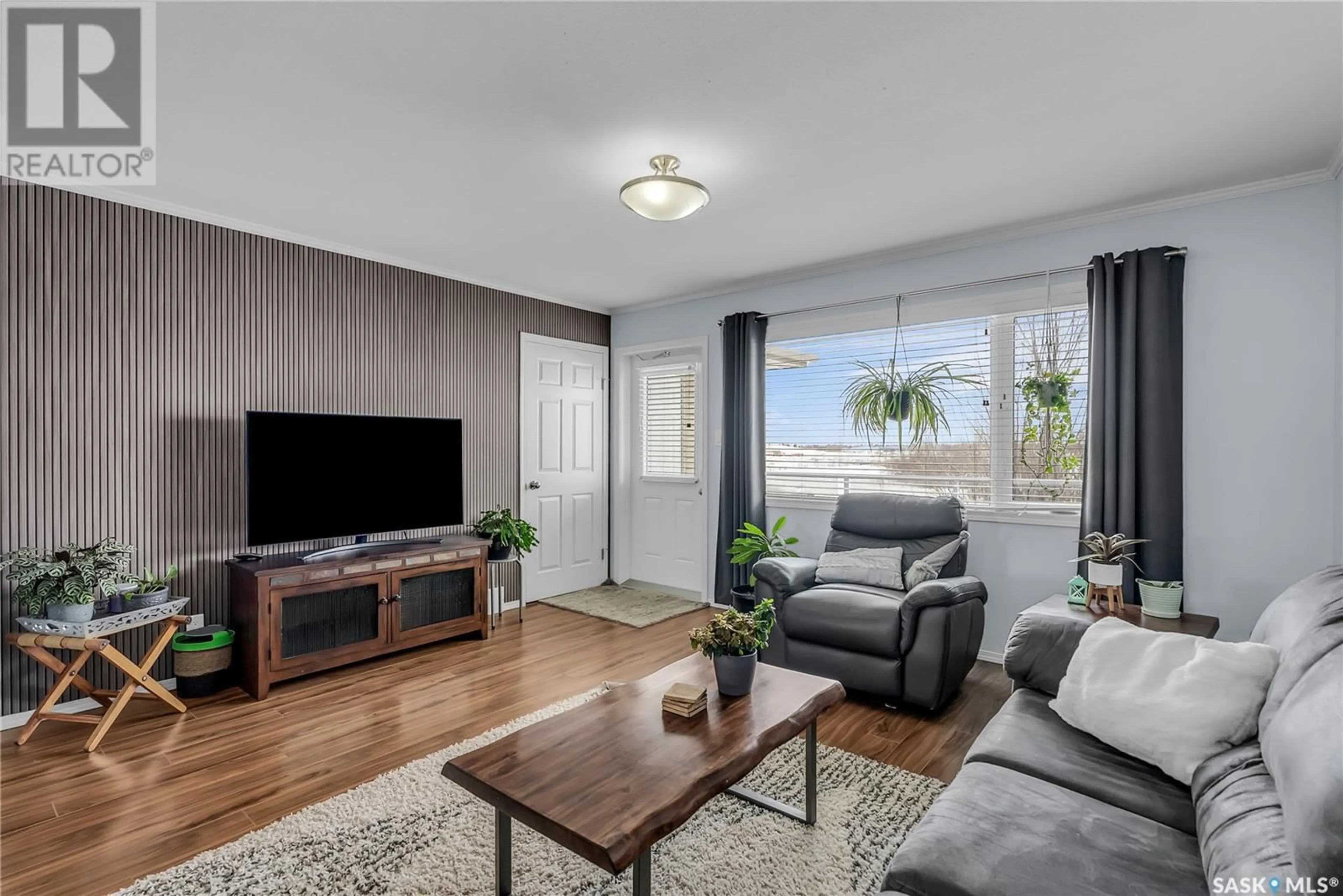 Living room with furniture, wood/laminate floor for 704 1303 Richardson ROAD, Saskatoon Saskatchewan S7R0L1