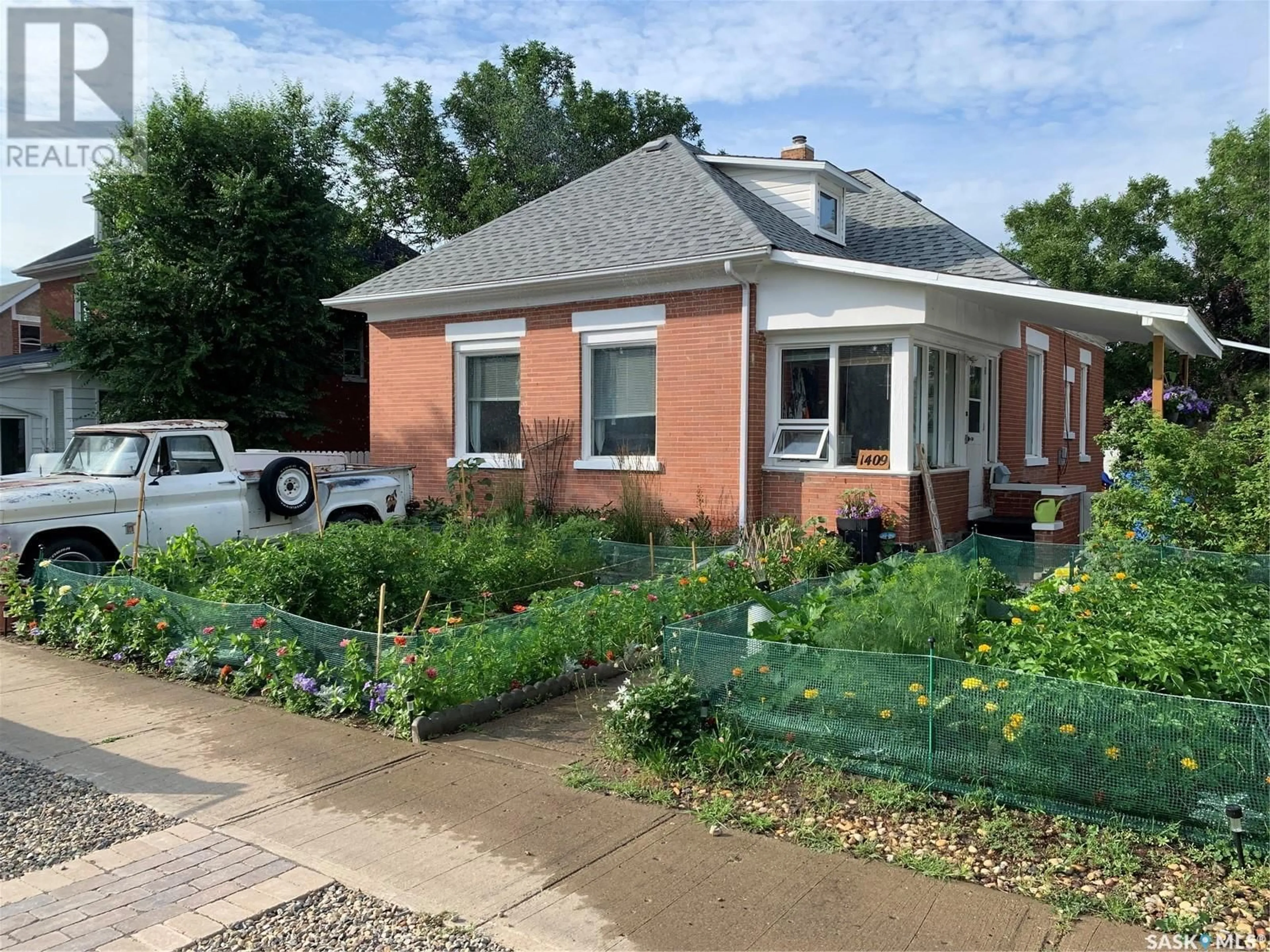 Home with brick exterior material, street for 1409 3rd STREET, Estevan Saskatchewan S4A0S3