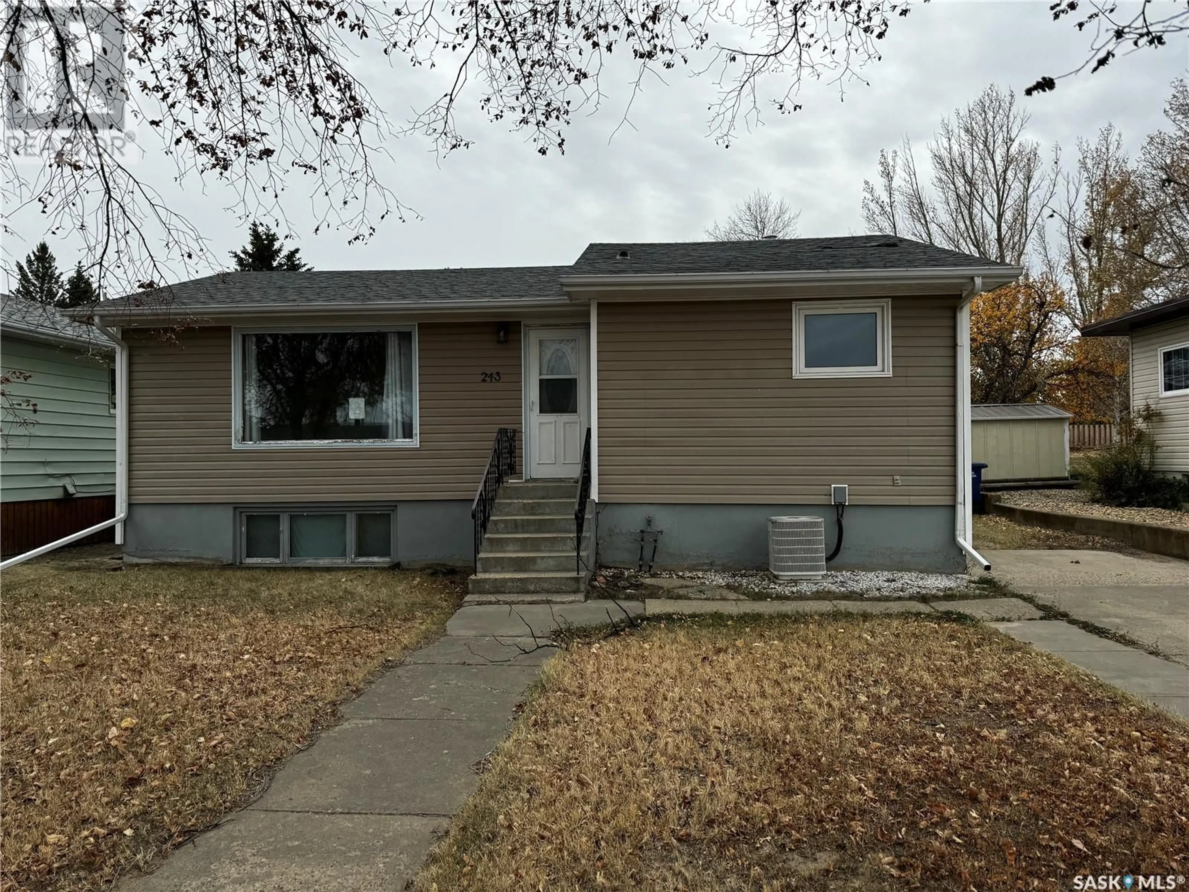 Home with vinyl exterior material, street for 243 Dominion ROAD, Assiniboia Saskatchewan S0H0B0