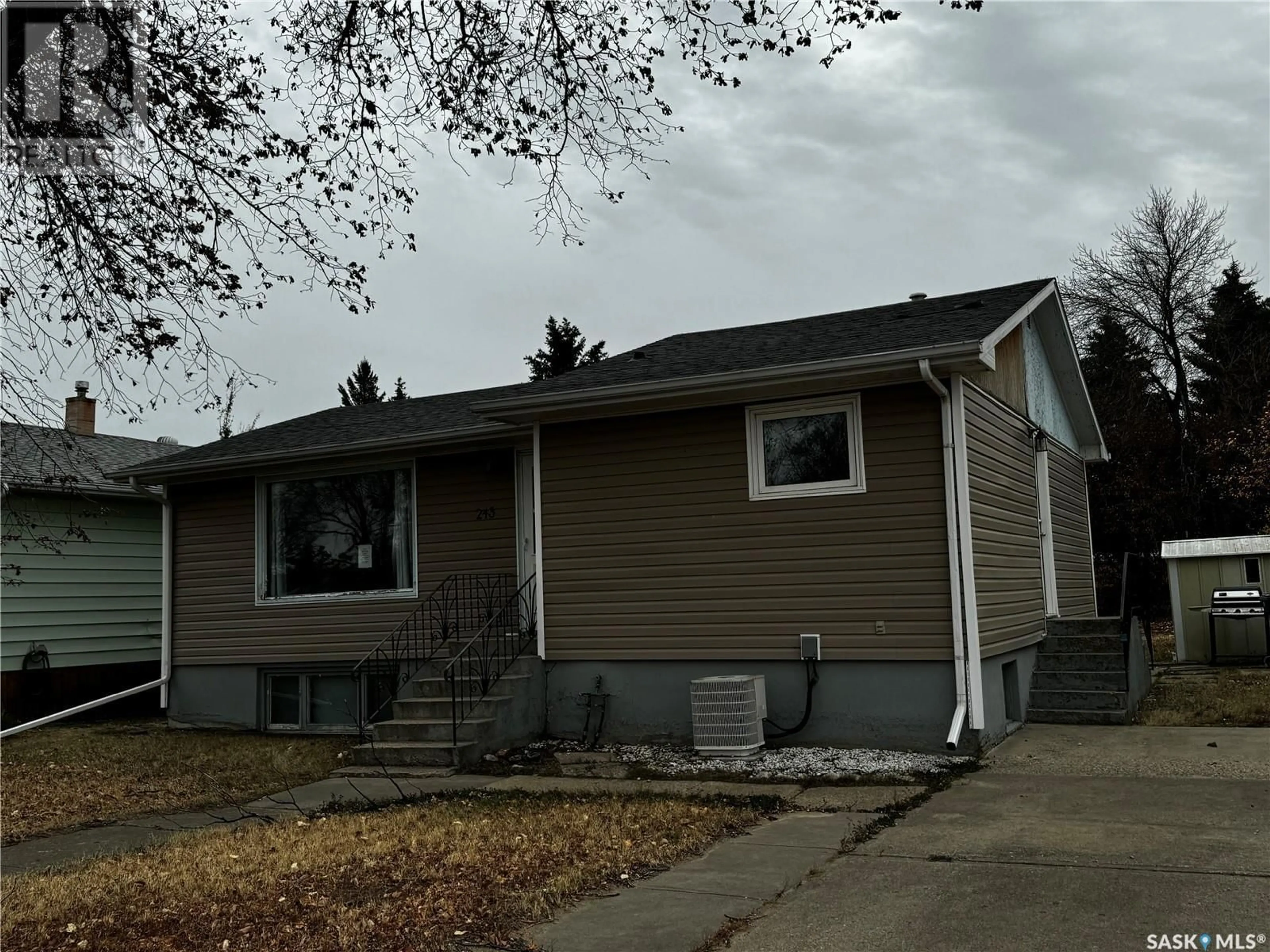 Home with vinyl exterior material, street for 243 Dominion ROAD, Assiniboia Saskatchewan S0H0B0