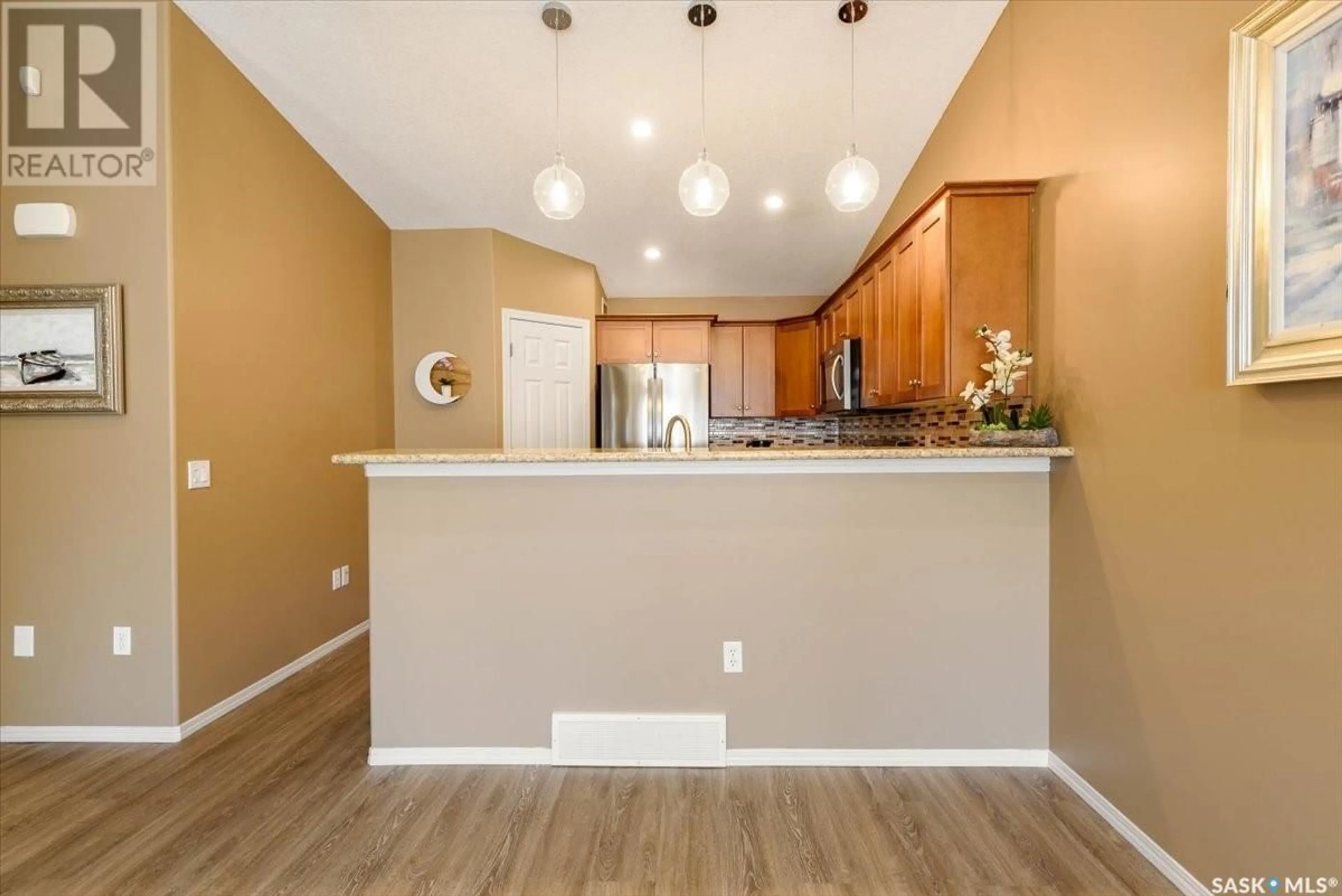 Open concept kitchen, wood/laminate floor for 37 2751 Windsor Park ROAD, Regina Saskatchewan S4V1H1