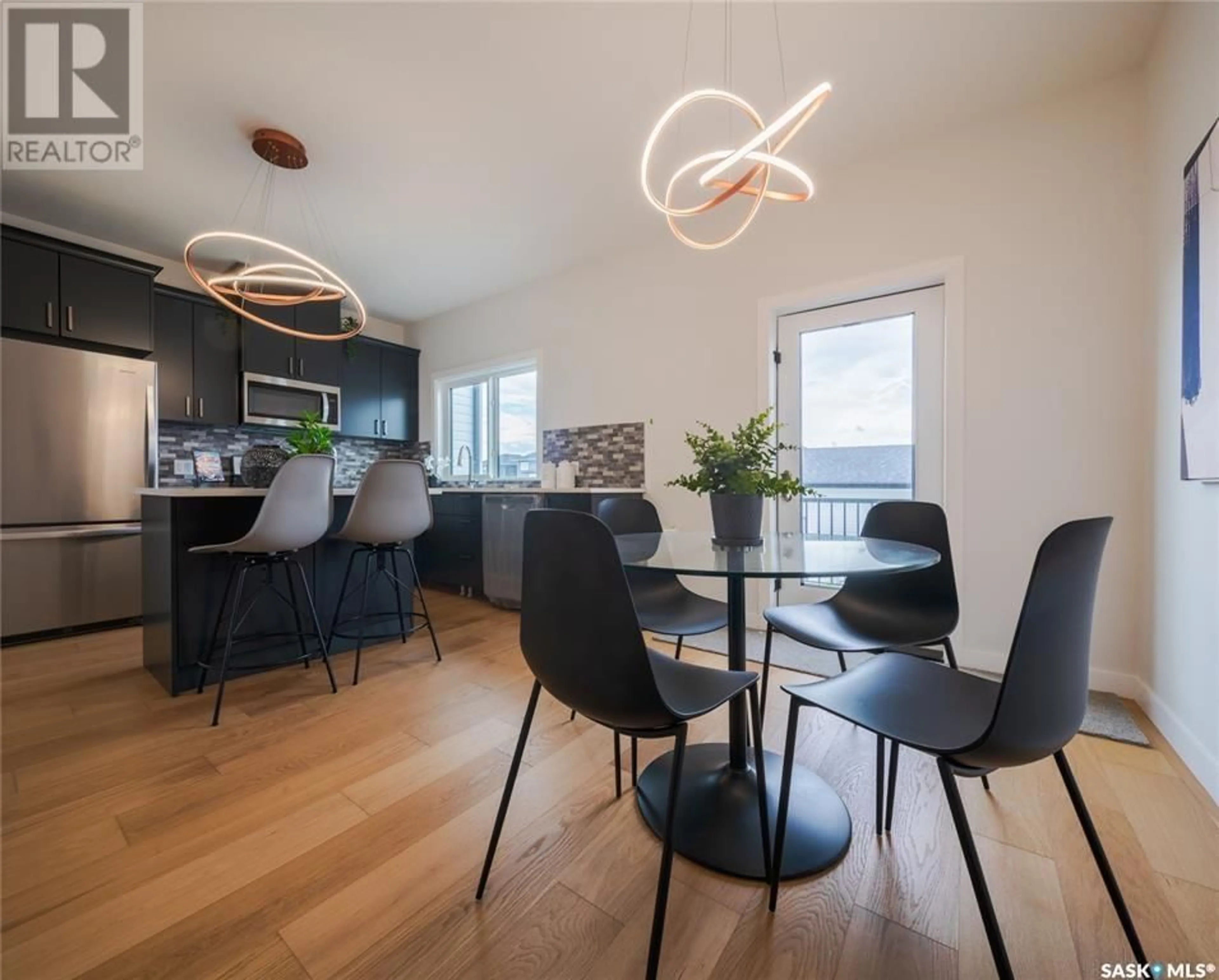 Open concept kitchen, wood/laminate floor for 203 - 235 FEHEREGYHAZI BOULEVARD, Saskatoon Saskatchewan S7W0C2