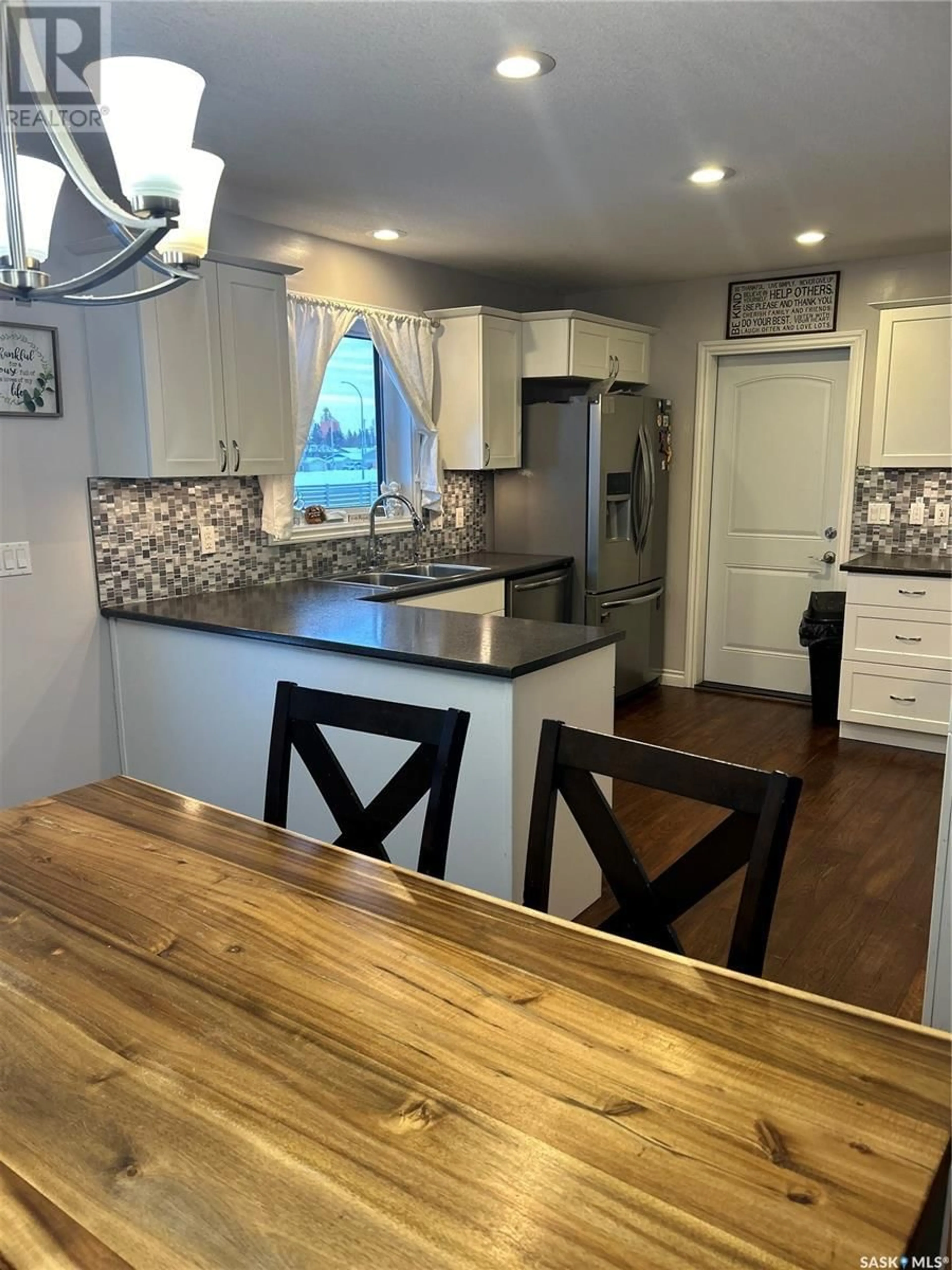 Open concept kitchen, wood/laminate floor for 521 5th E, Shellbrook Saskatchewan S0J2E0