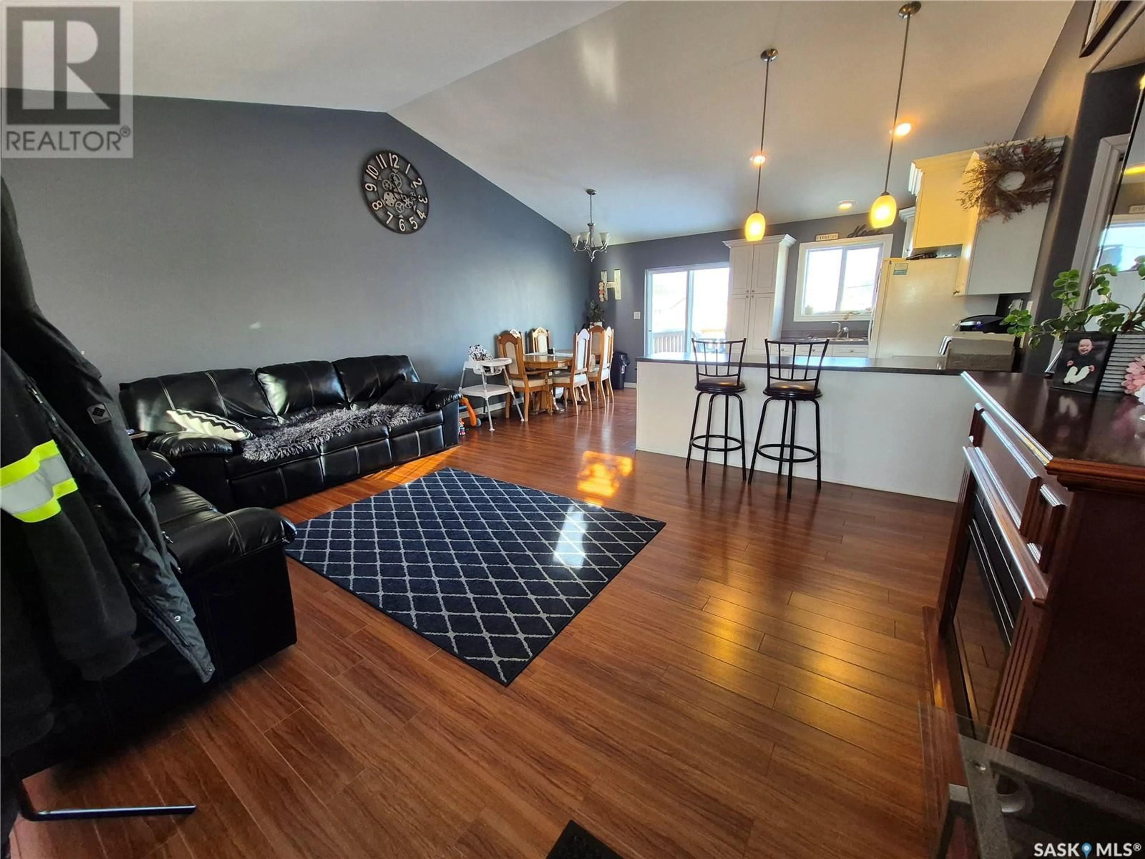 Living room with furniture, wood/laminate floor for 345 9th AVENUE SE, Weyburn Saskatchewan S4H3L7