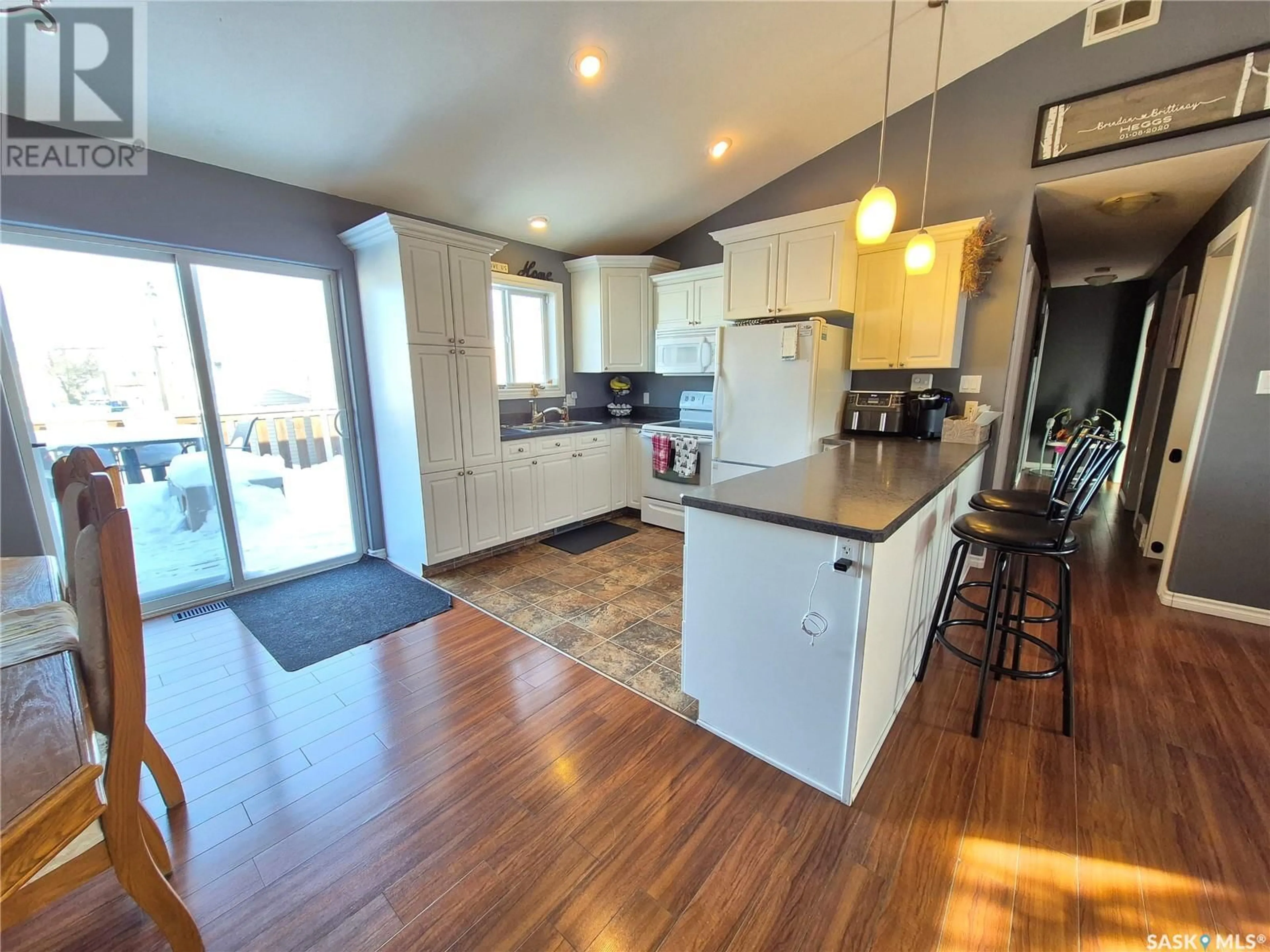 Open concept kitchen, wood/laminate floor for 345 9th AVENUE SE, Weyburn Saskatchewan S4H3L7