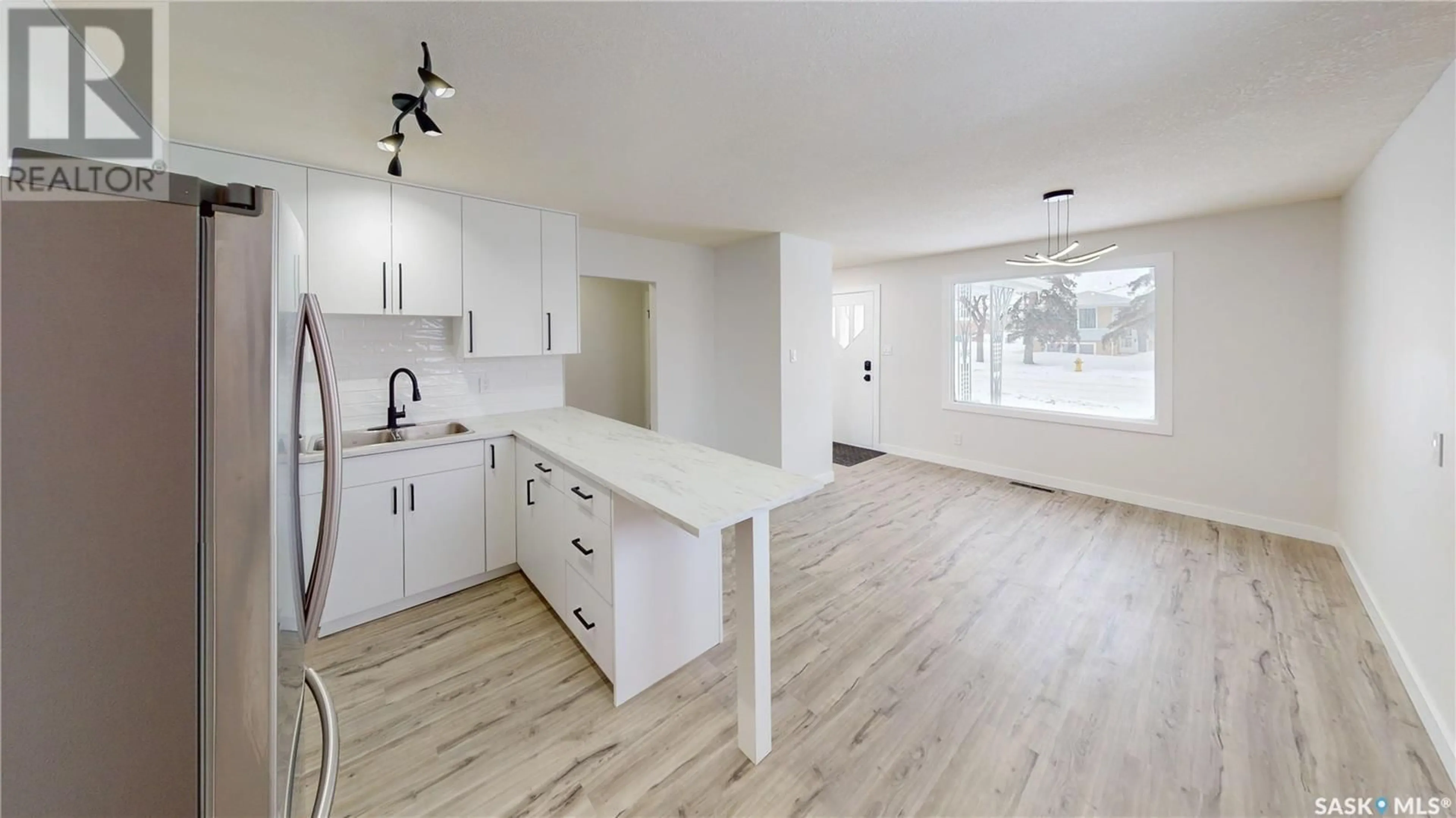 Open concept kitchen, wood/laminate floor for 446 Froom CRESCENT, Regina Saskatchewan S4N1T6