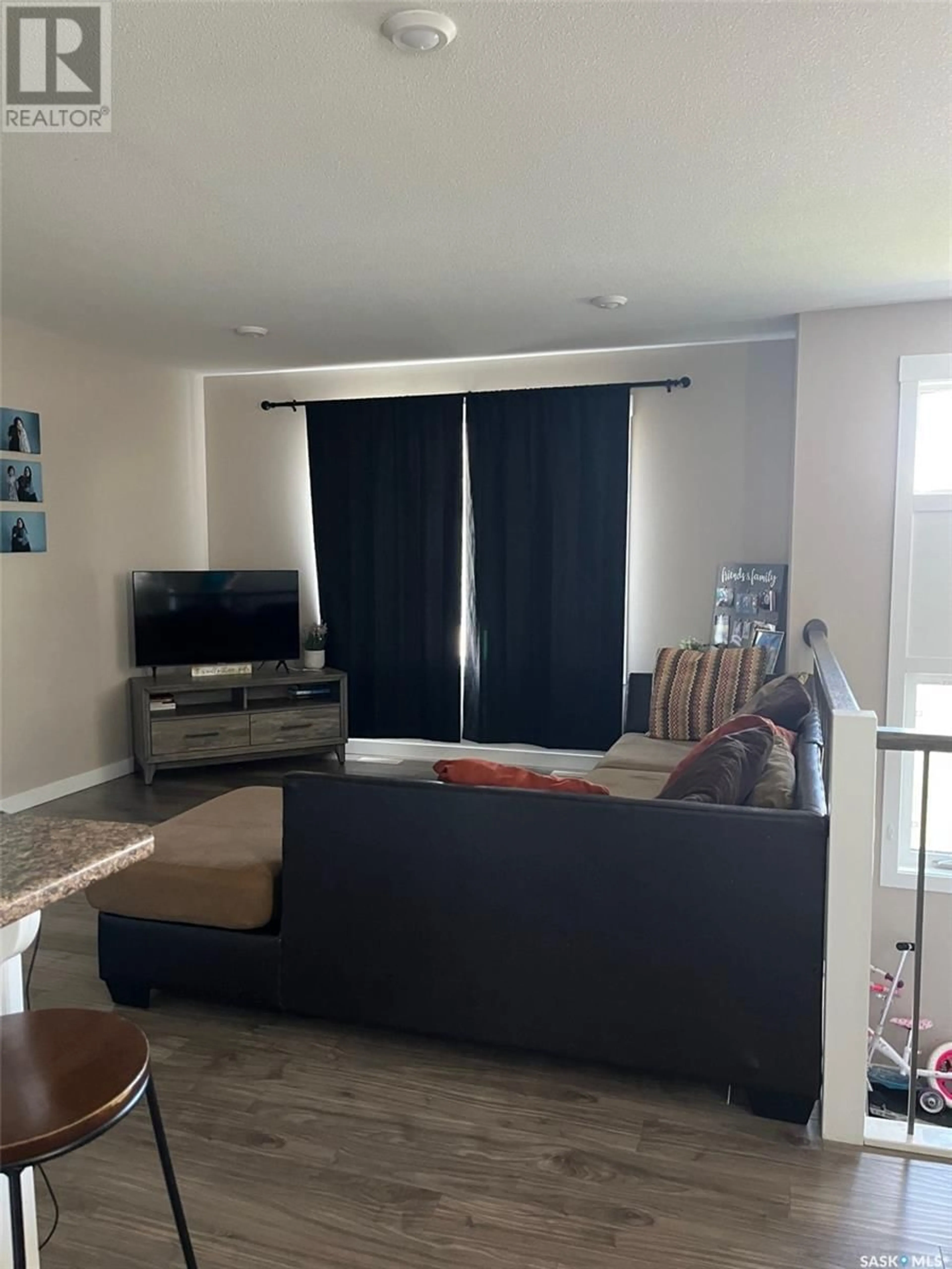 Living room with furniture, wood/laminate floor for E - 833 & 835 5TH STREET, Prince Albert Saskatchewan S6V6N1