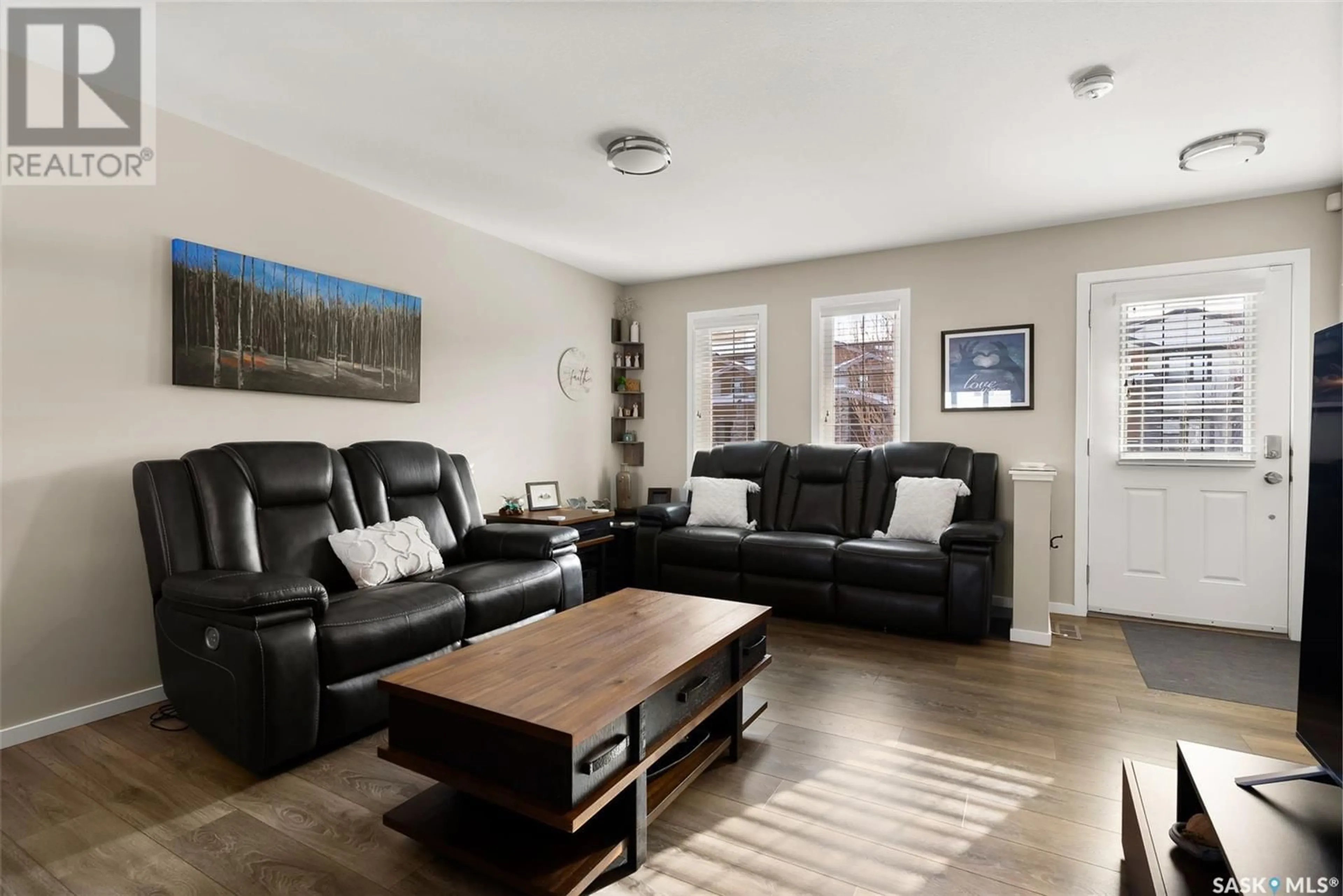 Living room with furniture, wood/laminate floor for 7960 Canola AVENUE, Regina Saskatchewan S4Y0E8