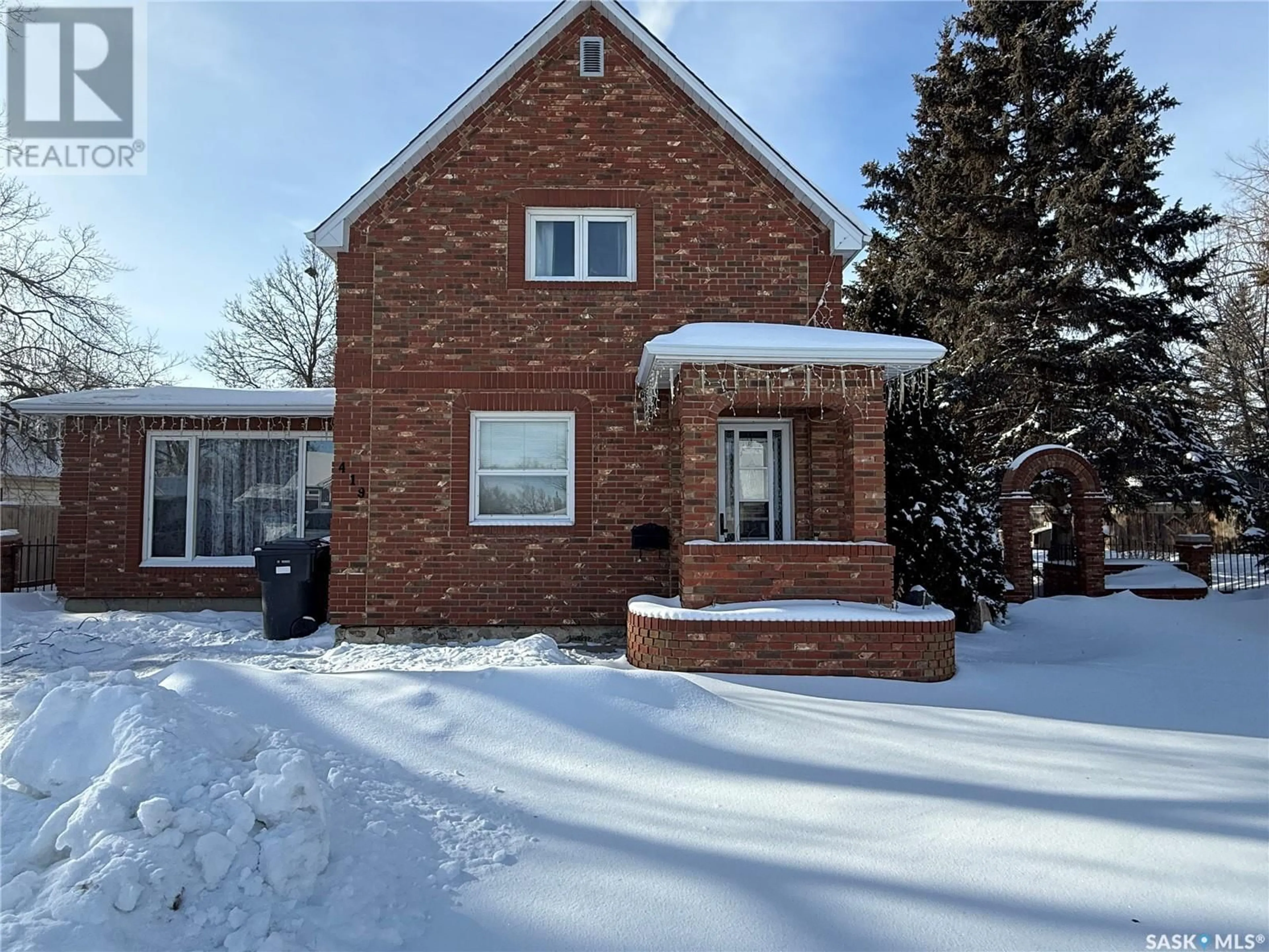 Home with brick exterior material, street for 419 Government ROAD N, Weyburn Saskatchewan S4H0P5