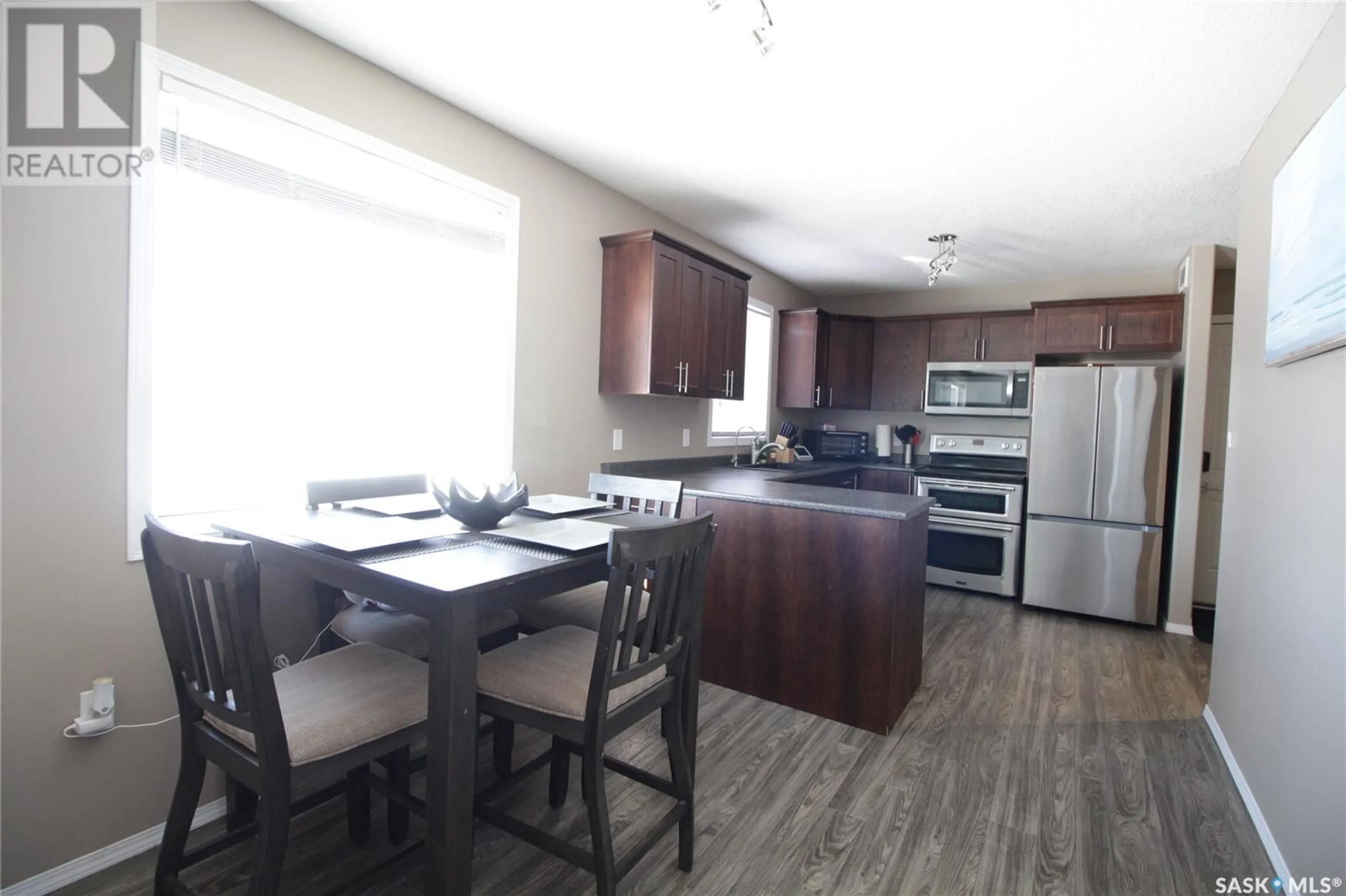 Open concept kitchen, wood/laminate floor for 519 Cook ROAD, Moosomin Saskatchewan S0G3N0