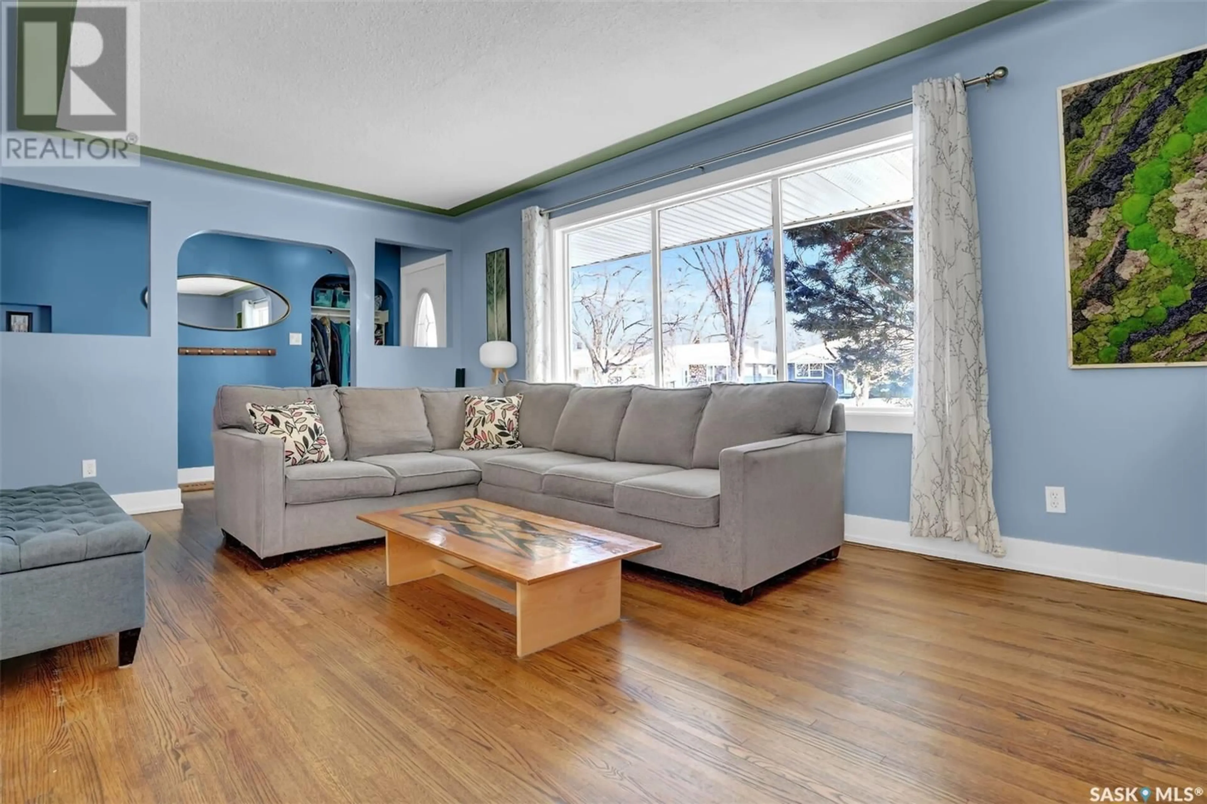 Living room with furniture, wood/laminate floor for 716 Empress STREET, Regina Saskatchewan S4T5C8