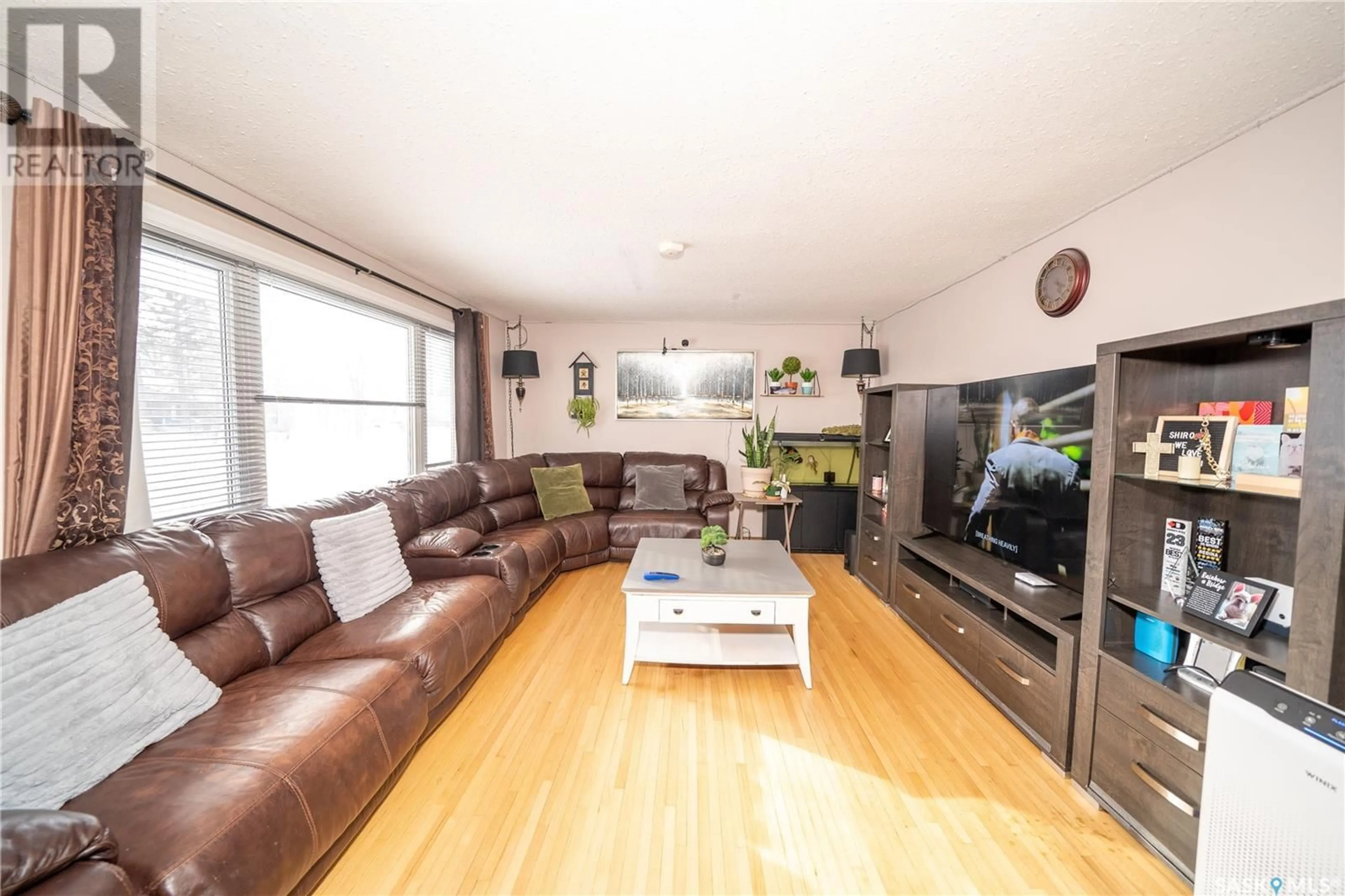 Living room with furniture, wood/laminate floor for 204 CAMBRIDGE AVENUE, Regina Saskatchewan S4N0L7