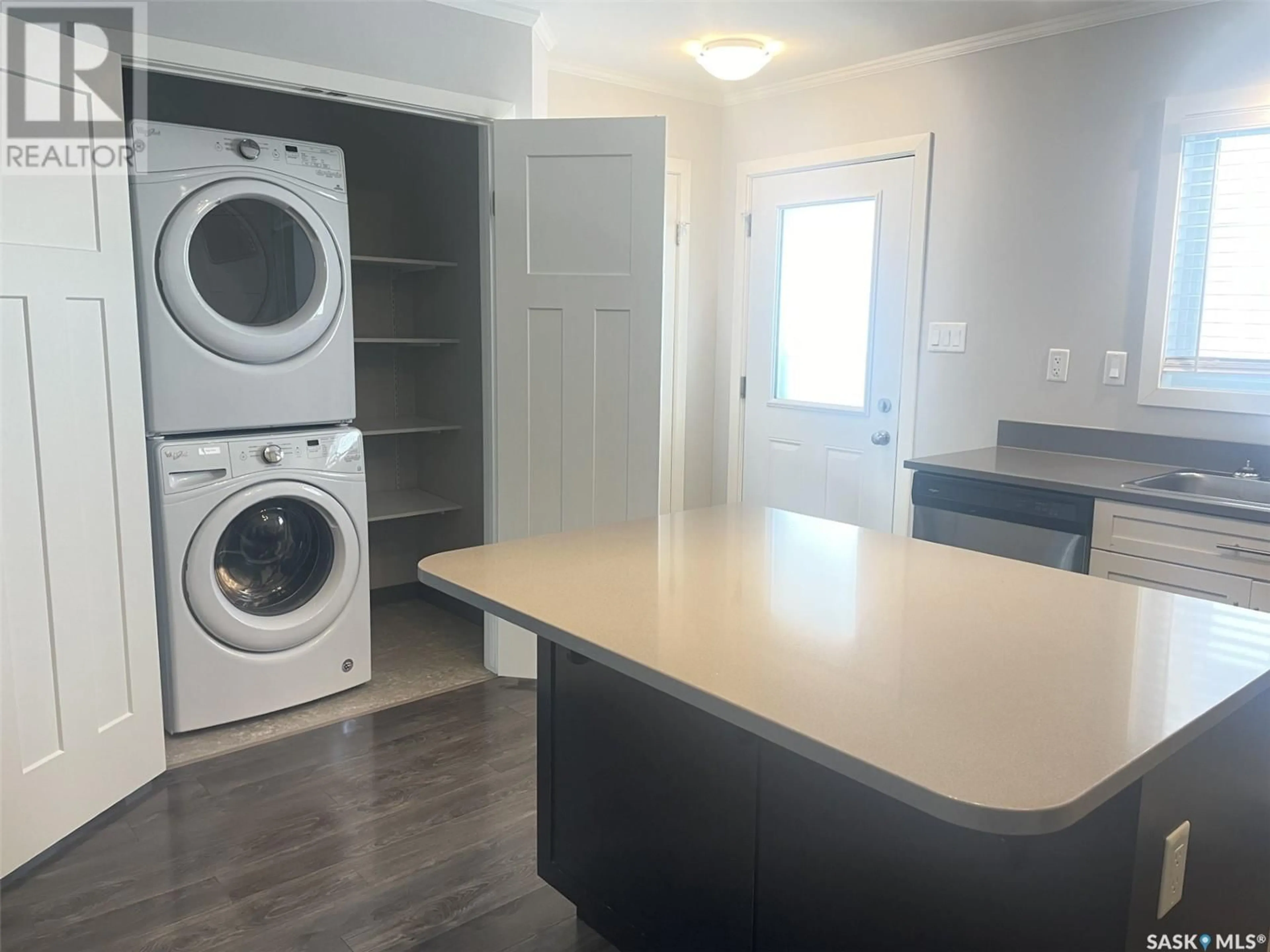 Kitchen with laundary machines, wood/laminate floor for 309 522 Cornish ROAD, Saskatoon Saskatchewan S7T0Z4