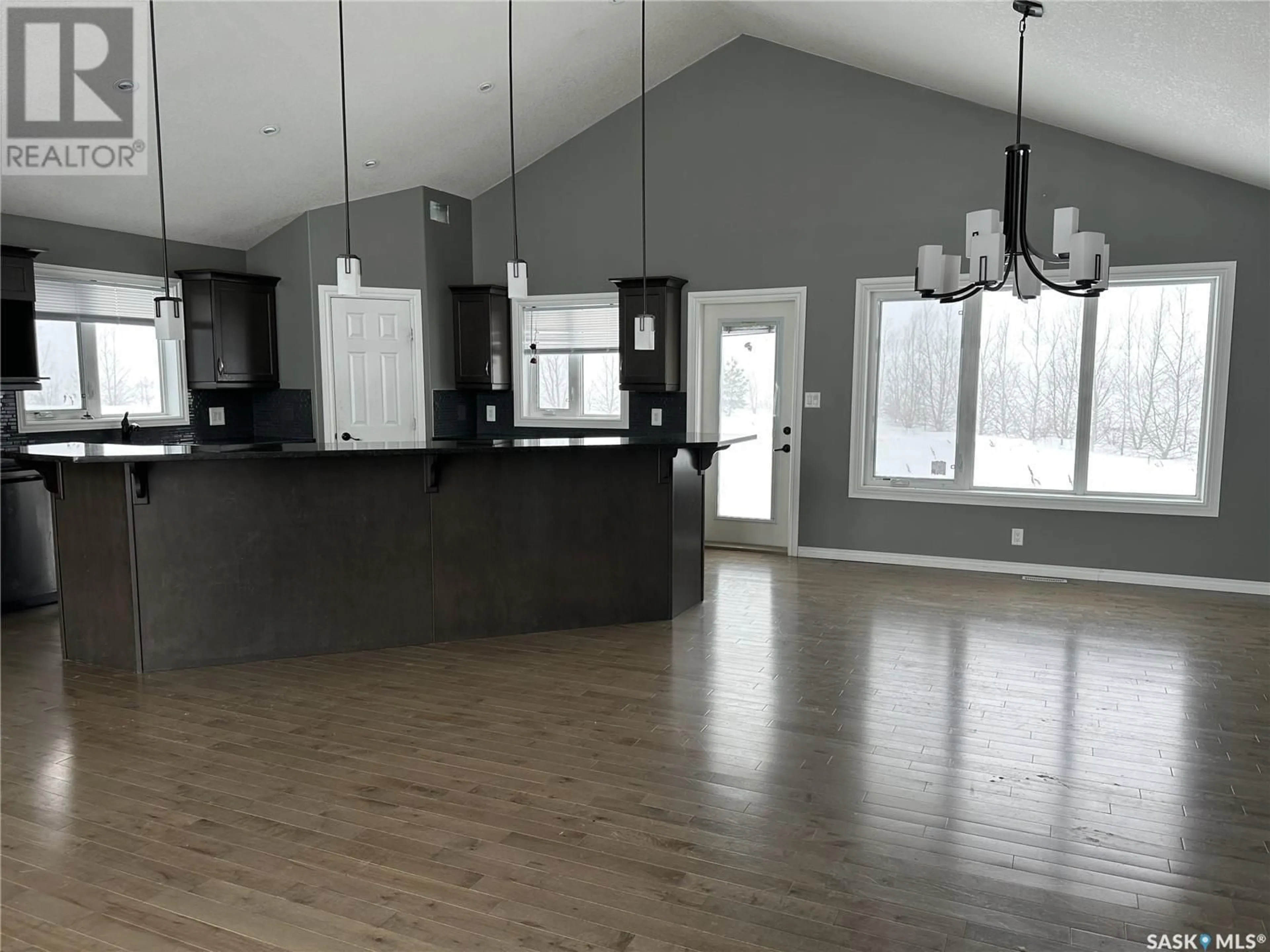 Open concept kitchen, wood/laminate floor for Acreage - Weyburn RM #67, Weyburn Rm No. 67 Saskatchewan S4H2K7