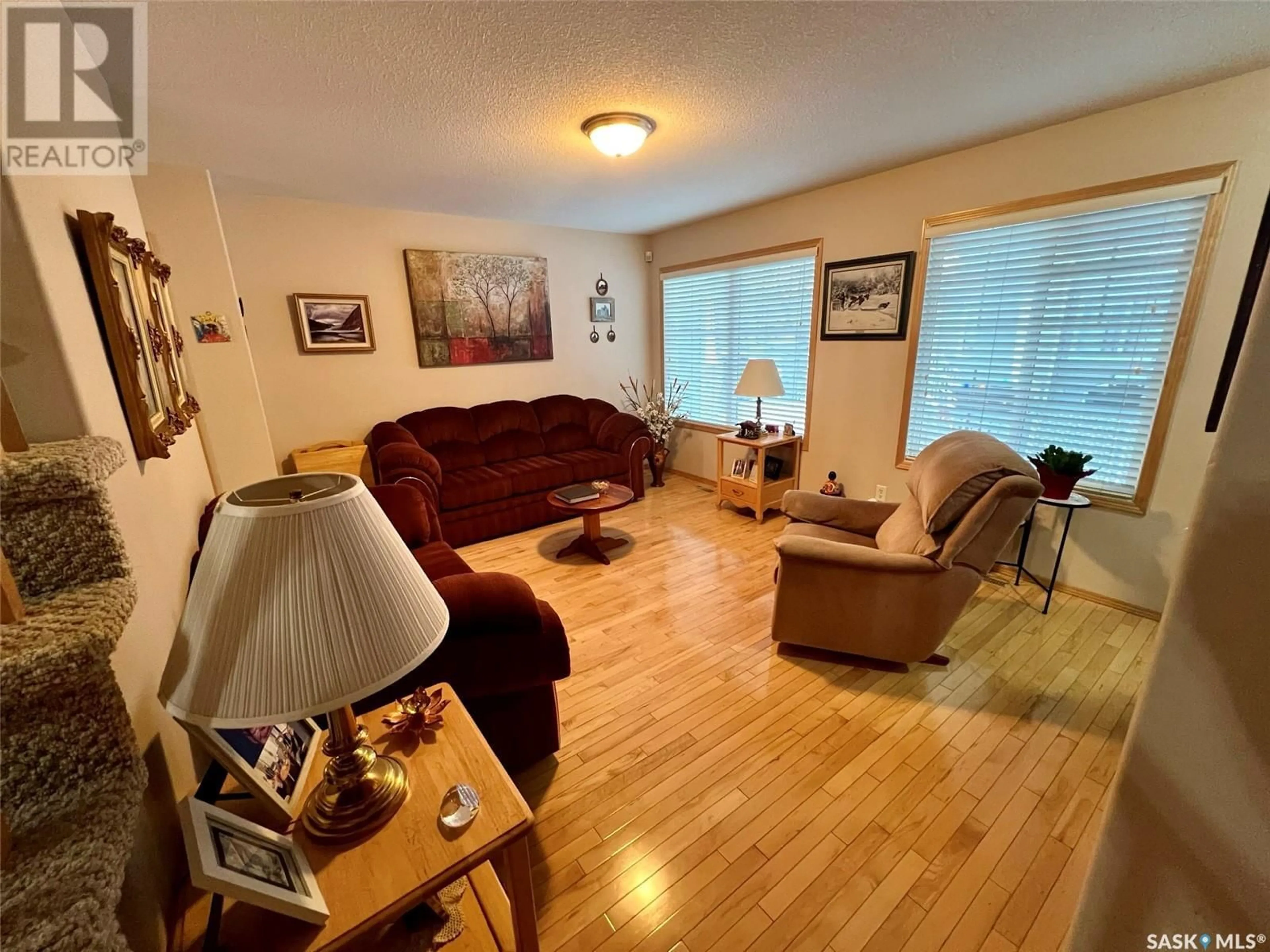 Living room with furniture, wood/laminate floor for 2229 Treetop LANE, Regina Saskatchewan S4P4V8