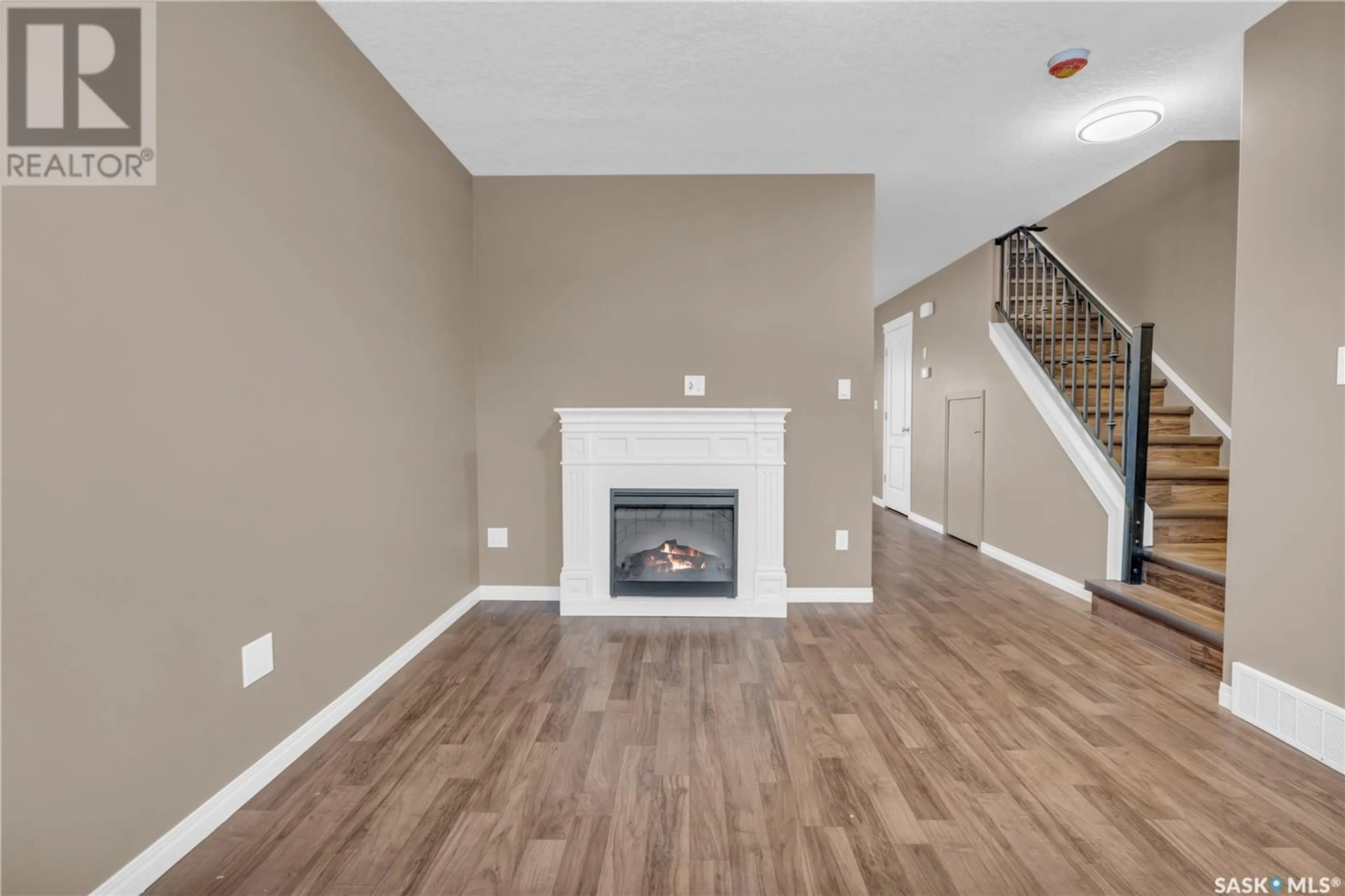 Living room with furniture, wood/laminate floor for 402 3826 Dewdney AVENUE E, Regina Saskatchewan S4Z0A1