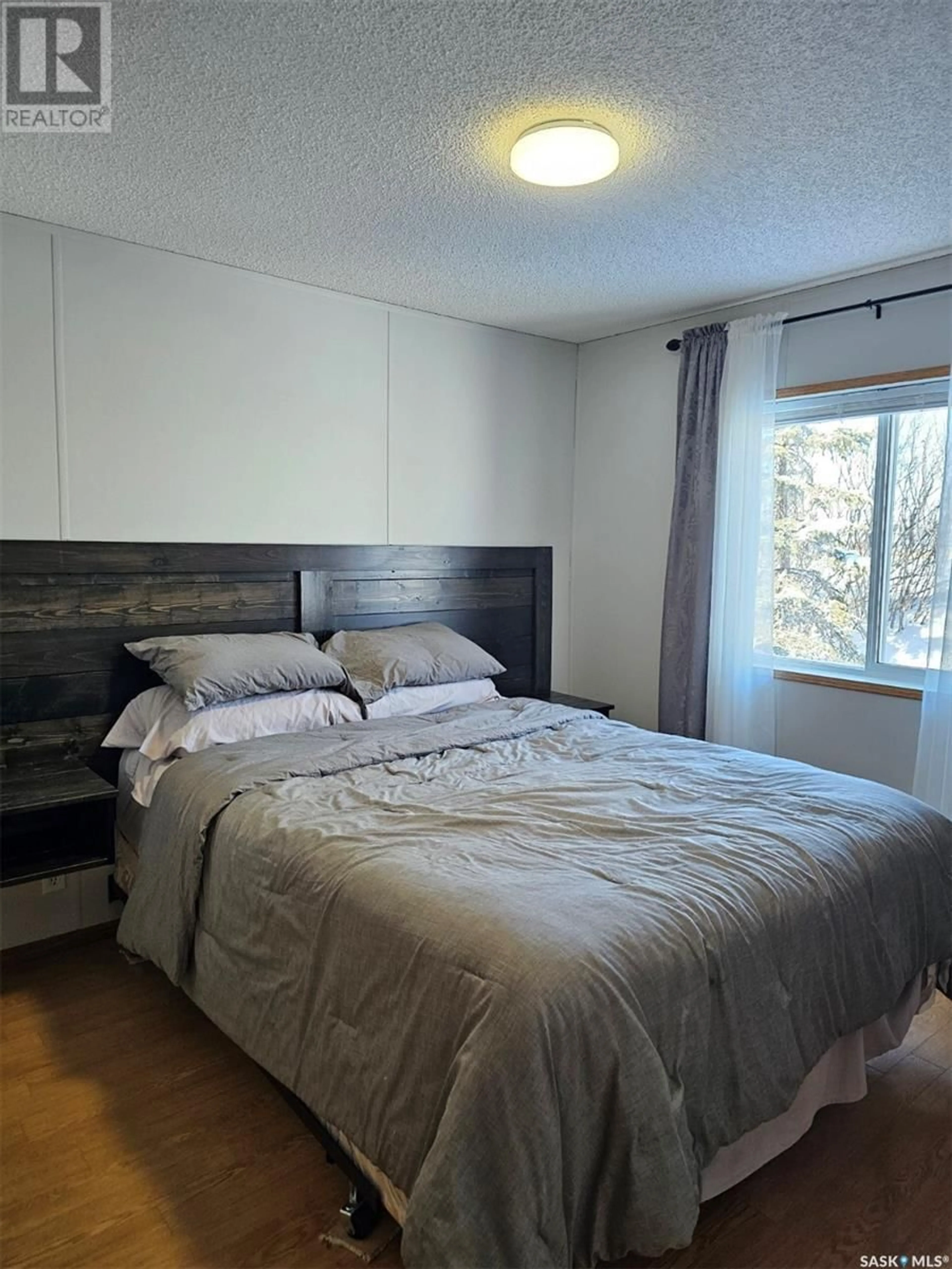 Bedroom with bed, wood/laminate floor for 224 Center STREET, Mccord Saskatchewan S0H2T0