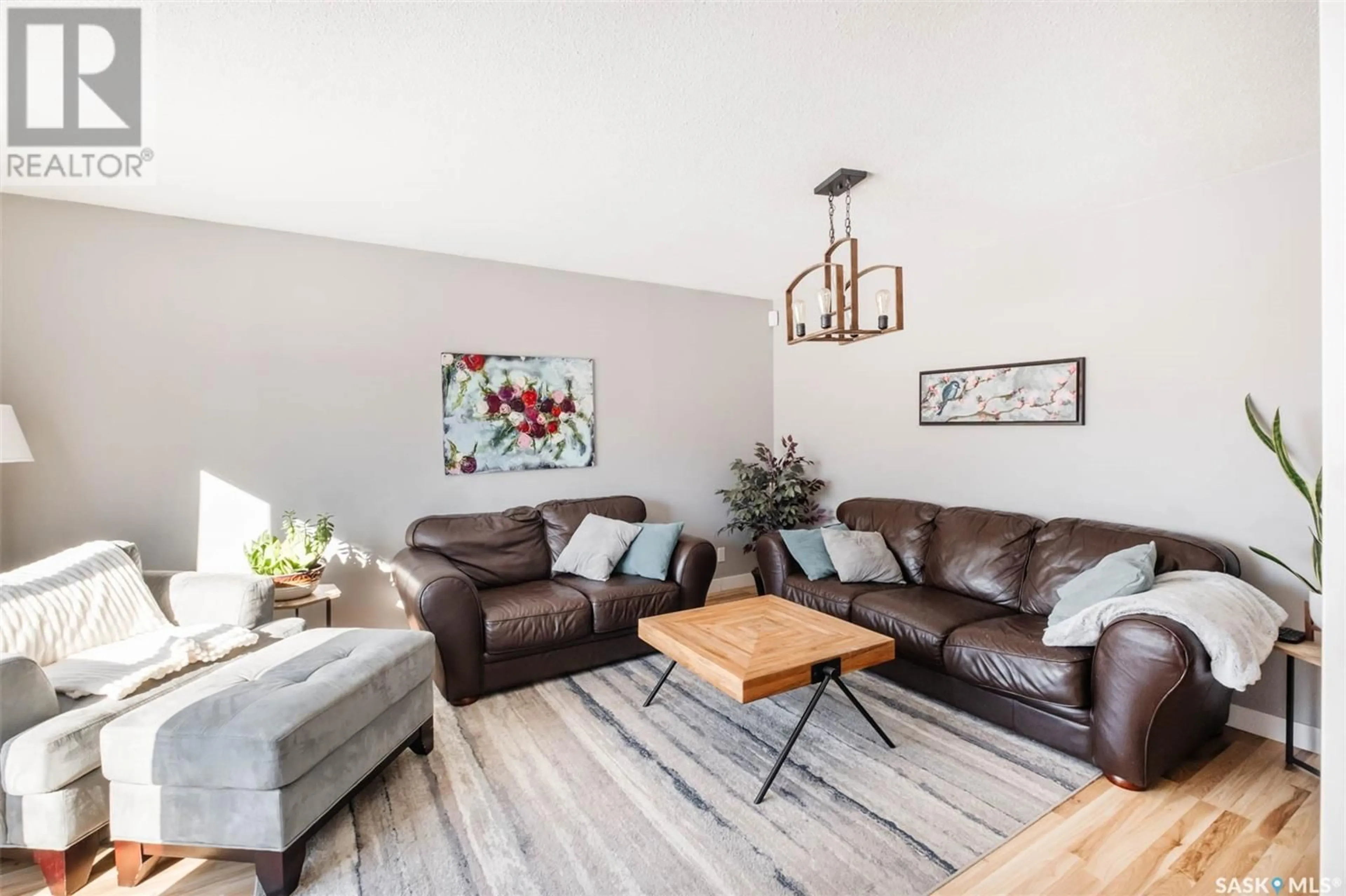 Living room with furniture, wood/laminate floor for 6106 1st AVENUE N, Regina Saskatchewan S4T6Z7