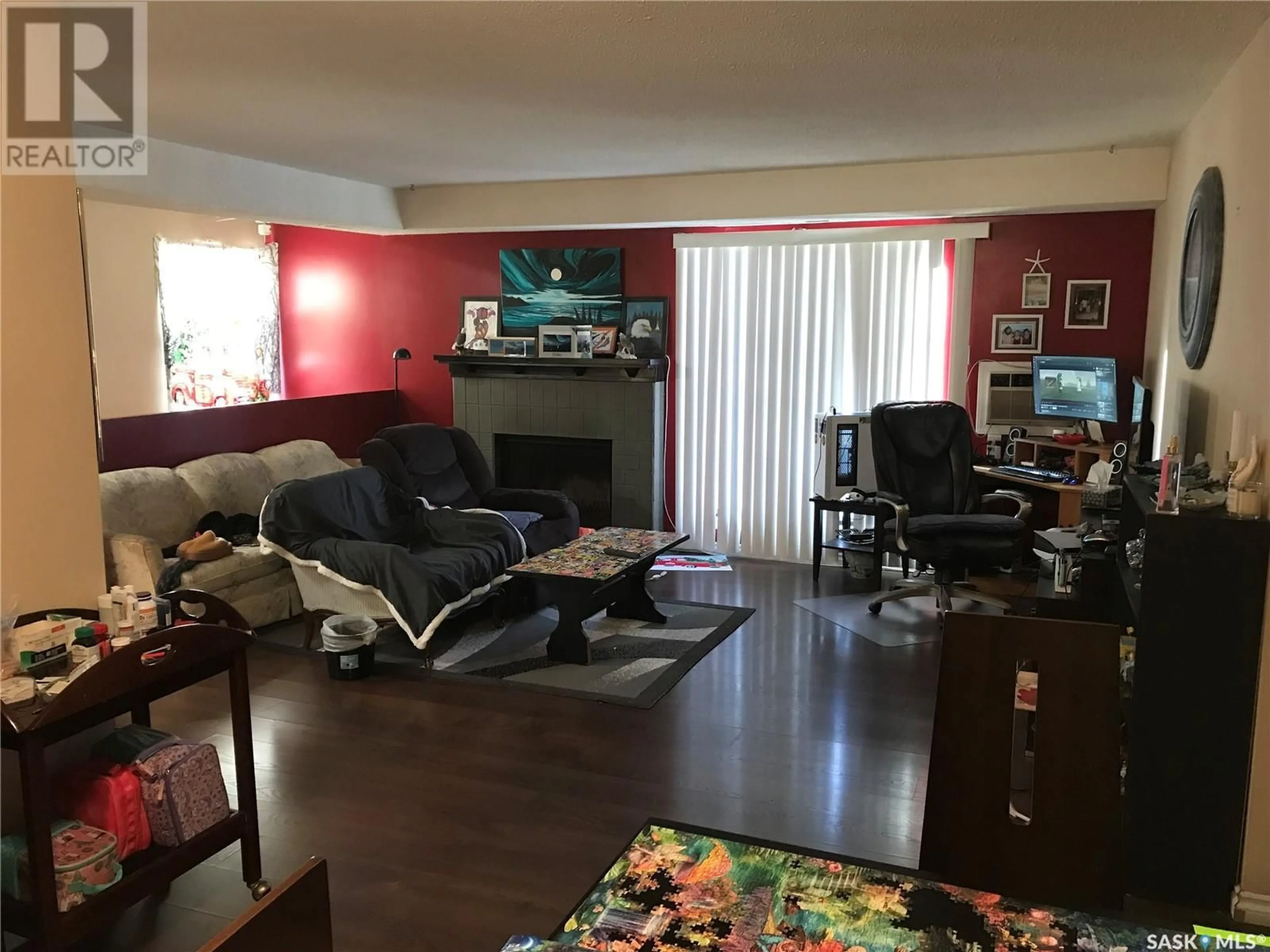 Living room with furniture, wood/laminate floor for 204 457 Pendygrasse ROAD, Saskatoon Saskatchewan S7M5H3