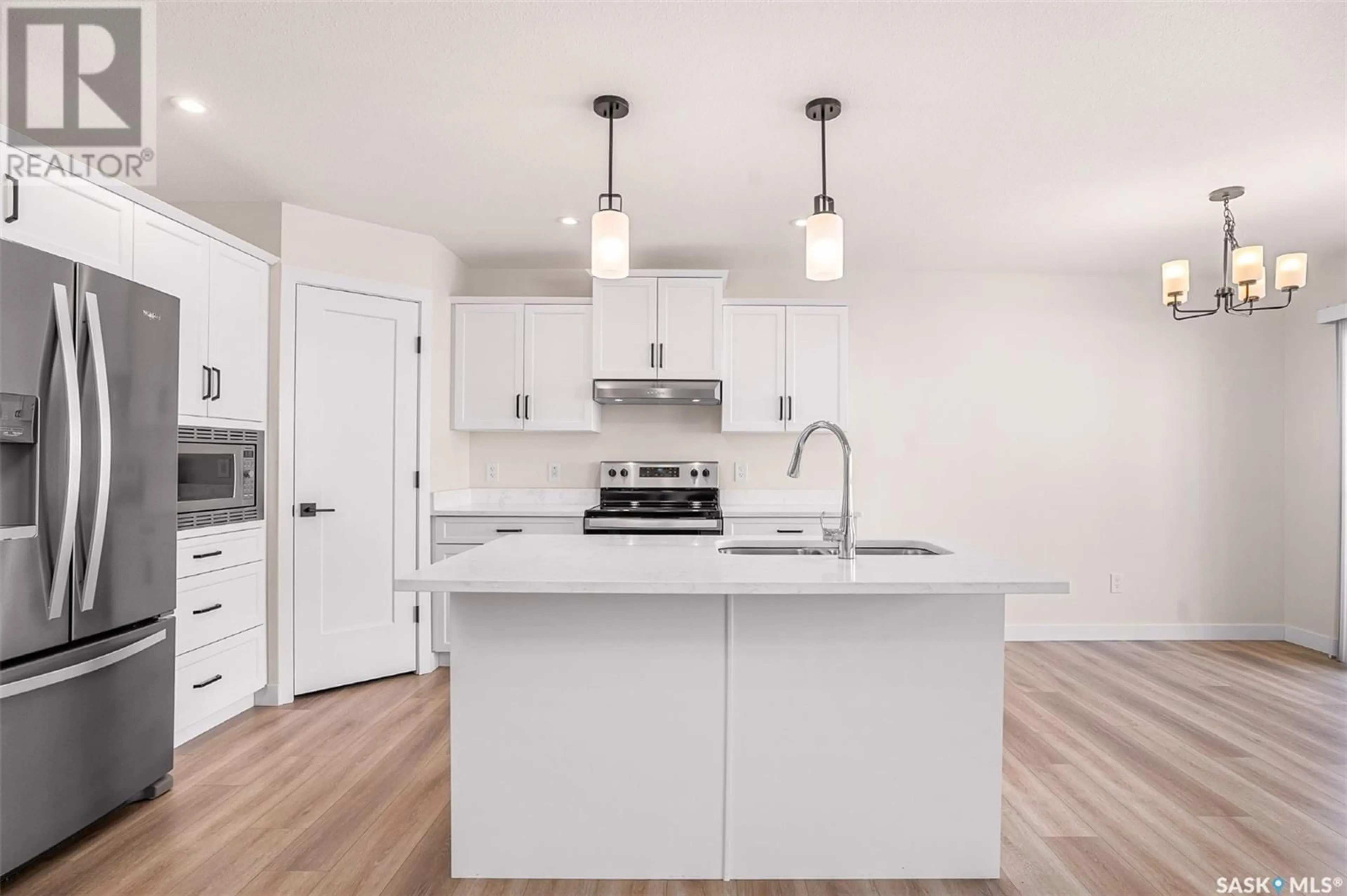 Open concept kitchen, wood/laminate floor for 365 Chelsom MANOR, Saskatoon Saskatchewan S0K2T0