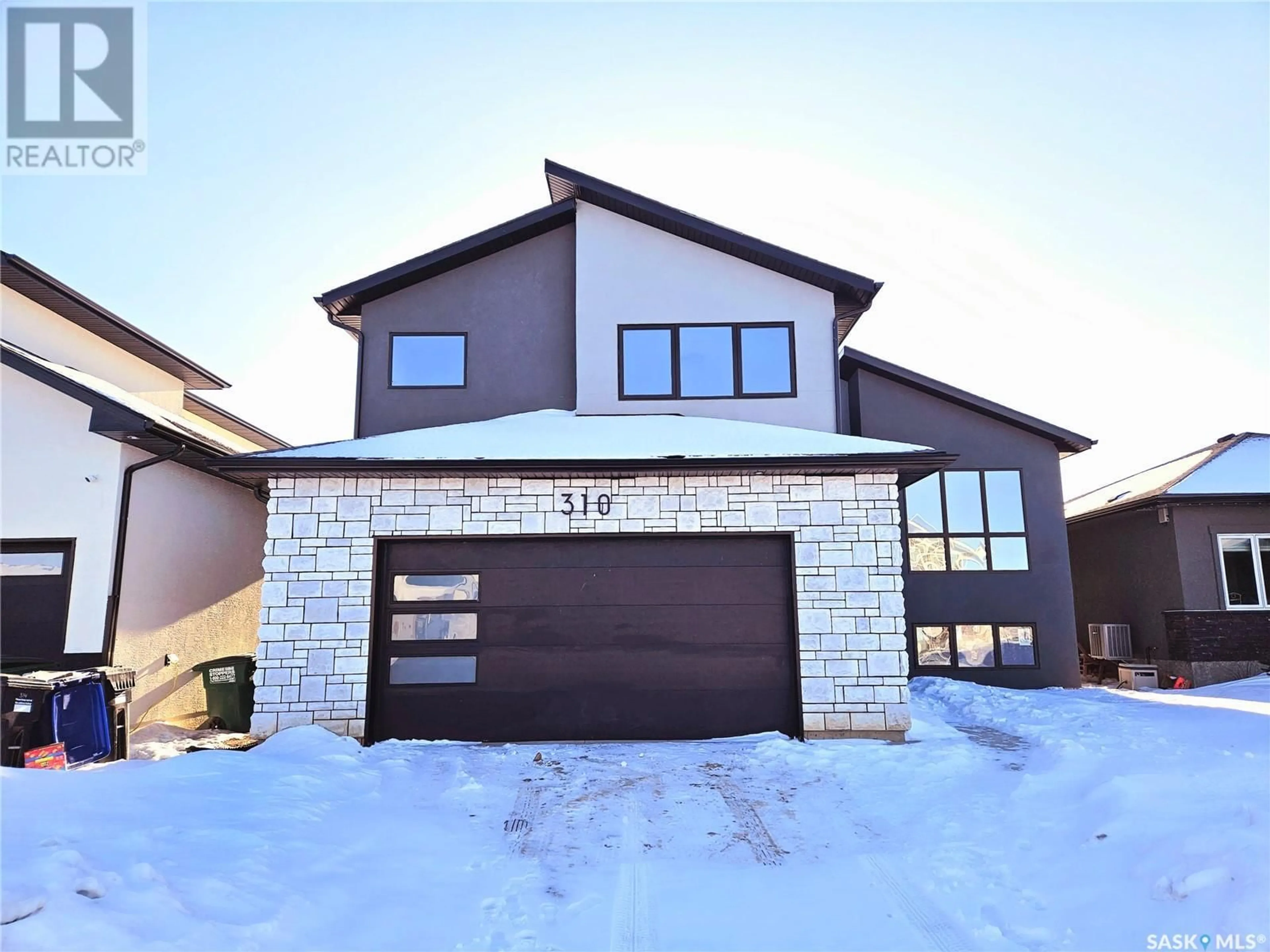 Home with brick exterior material, street for 310 FLYNN MANOR, Saskatoon Saskatchewan S7V0Z4