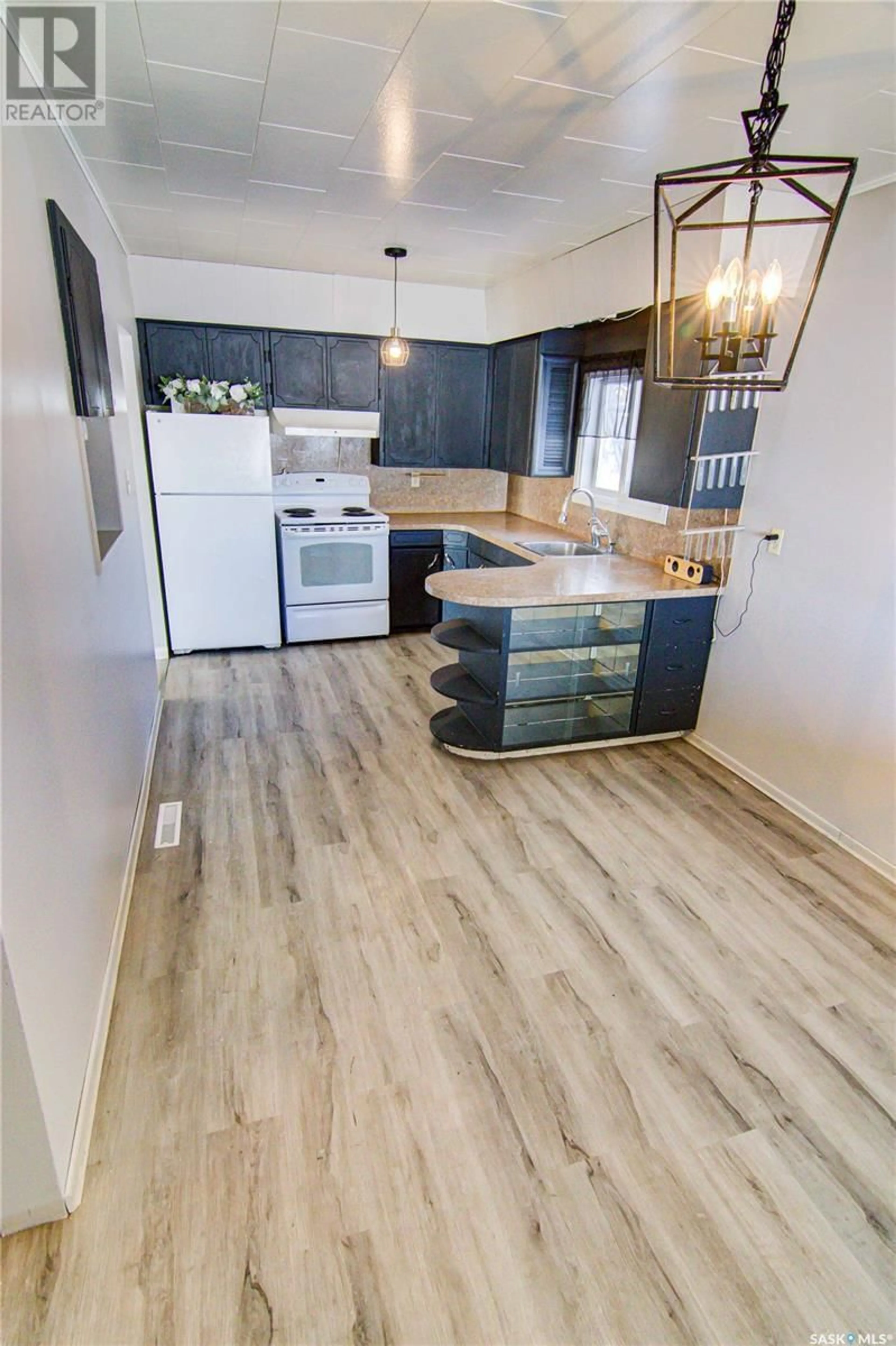 Open concept kitchen, wood/laminate floor for Brooksby Acreage 19.32 Acres, Willow Creek Rm No. 458 Saskatchewan S0E0H0