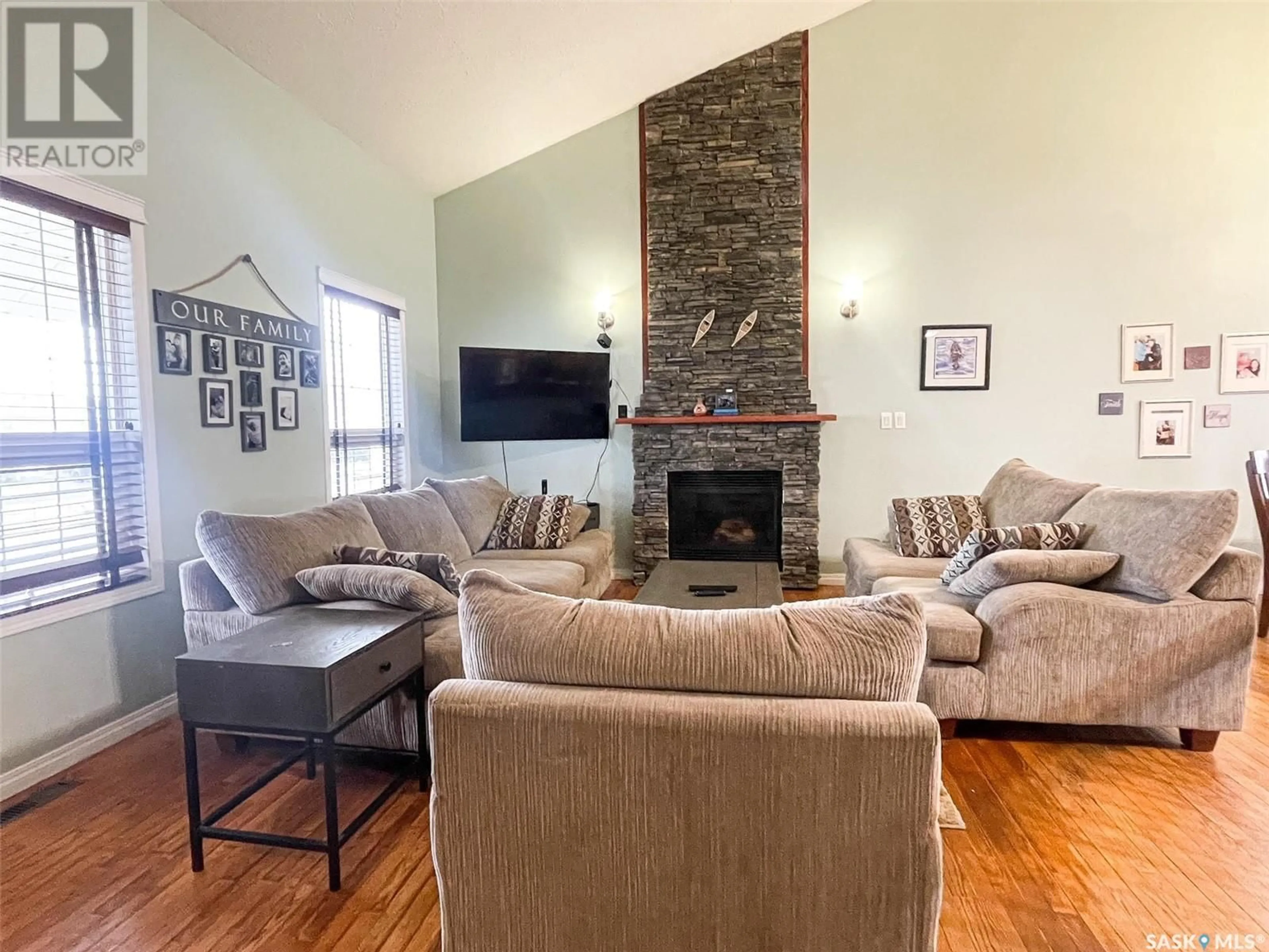 Living room with furniture, wood/laminate floor for 14 Jackson DRIVE, Meadow Lake Saskatchewan S9X1T9