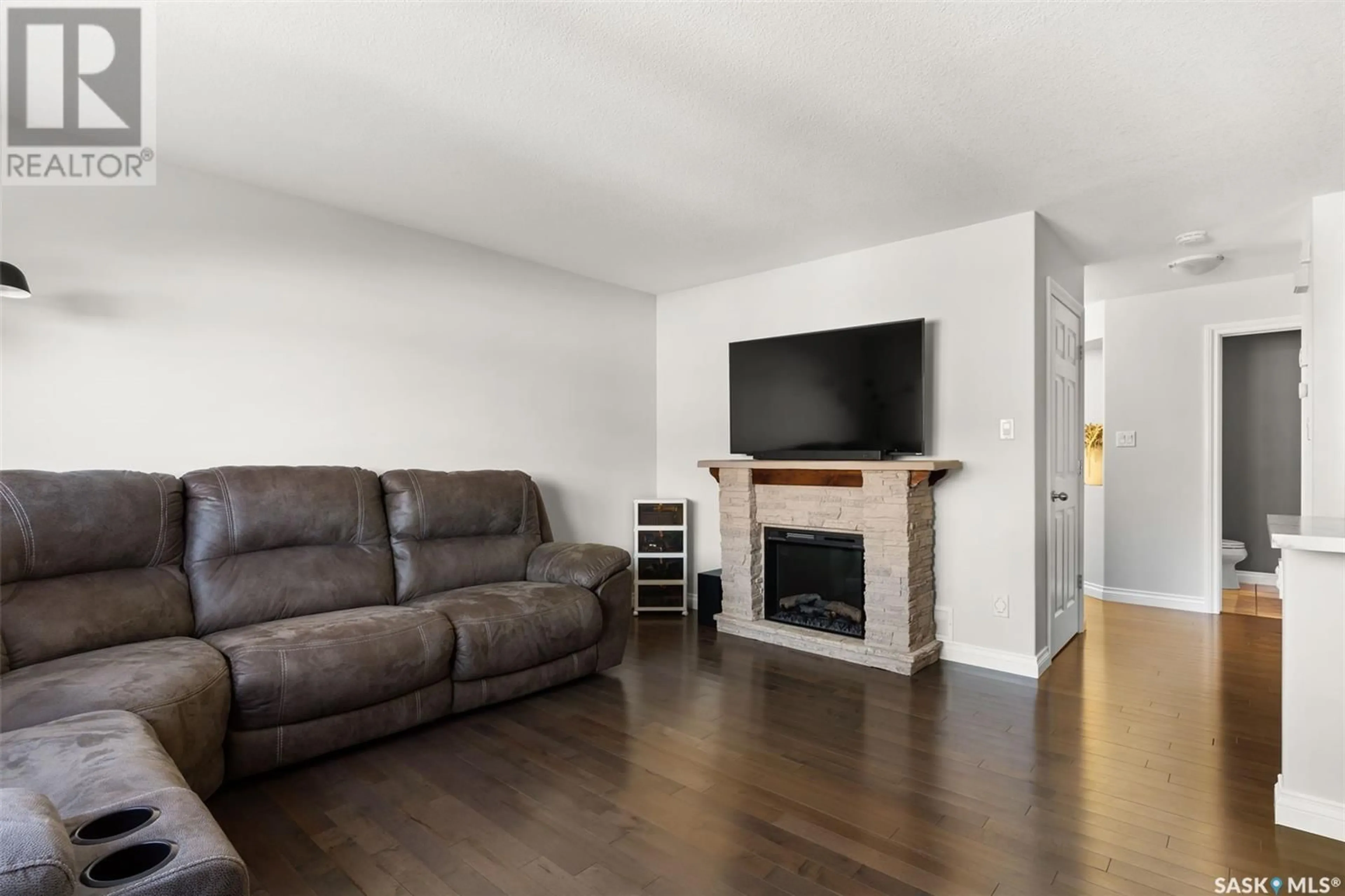 Living room with furniture, wood/laminate floor for 4326 Meadowsweet LANE, Regina Saskatchewan S4X0C2