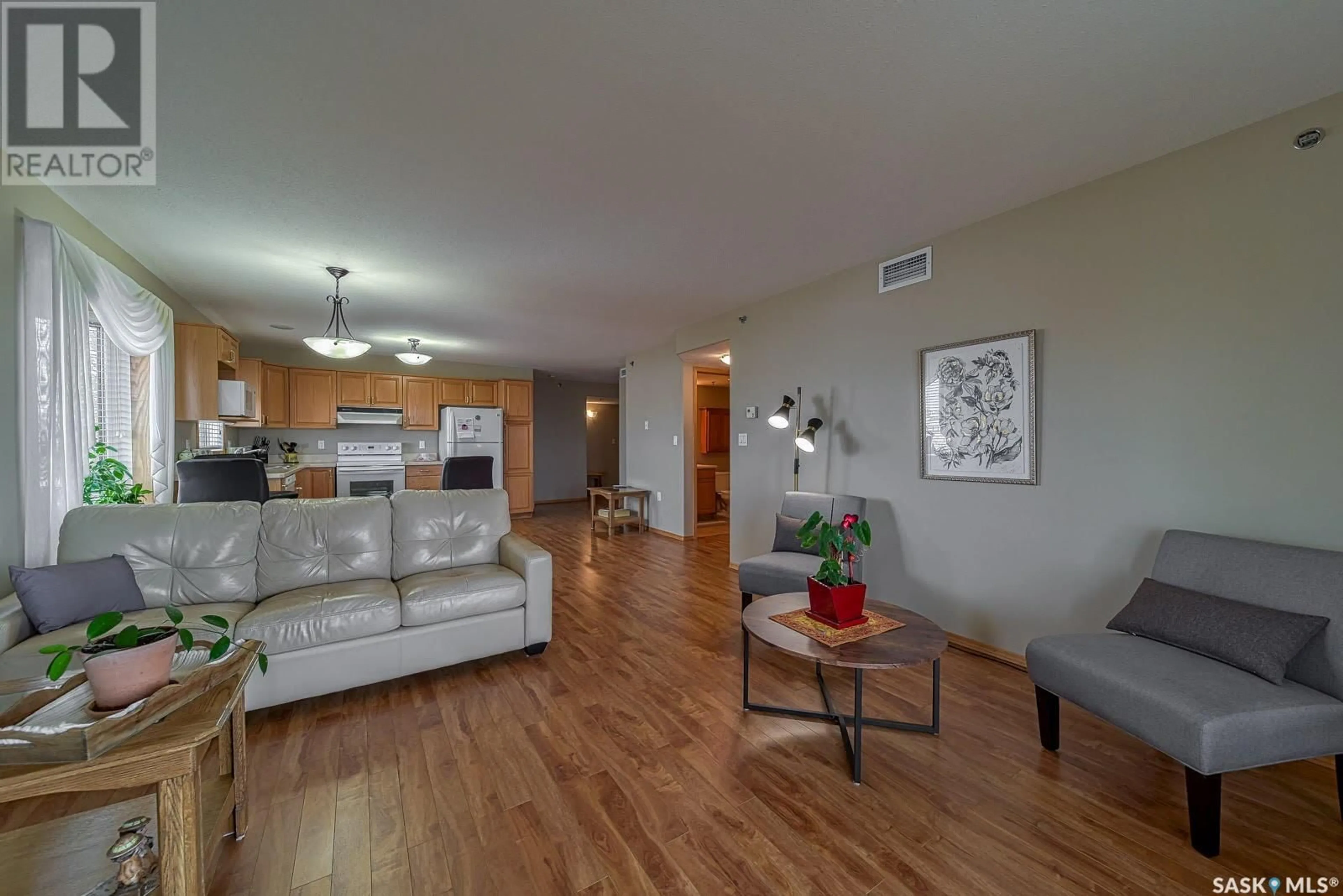 Living room with furniture, wood/laminate floor for 401 205 McIntyre STREET N, Regina Saskatchewan S4R3B7