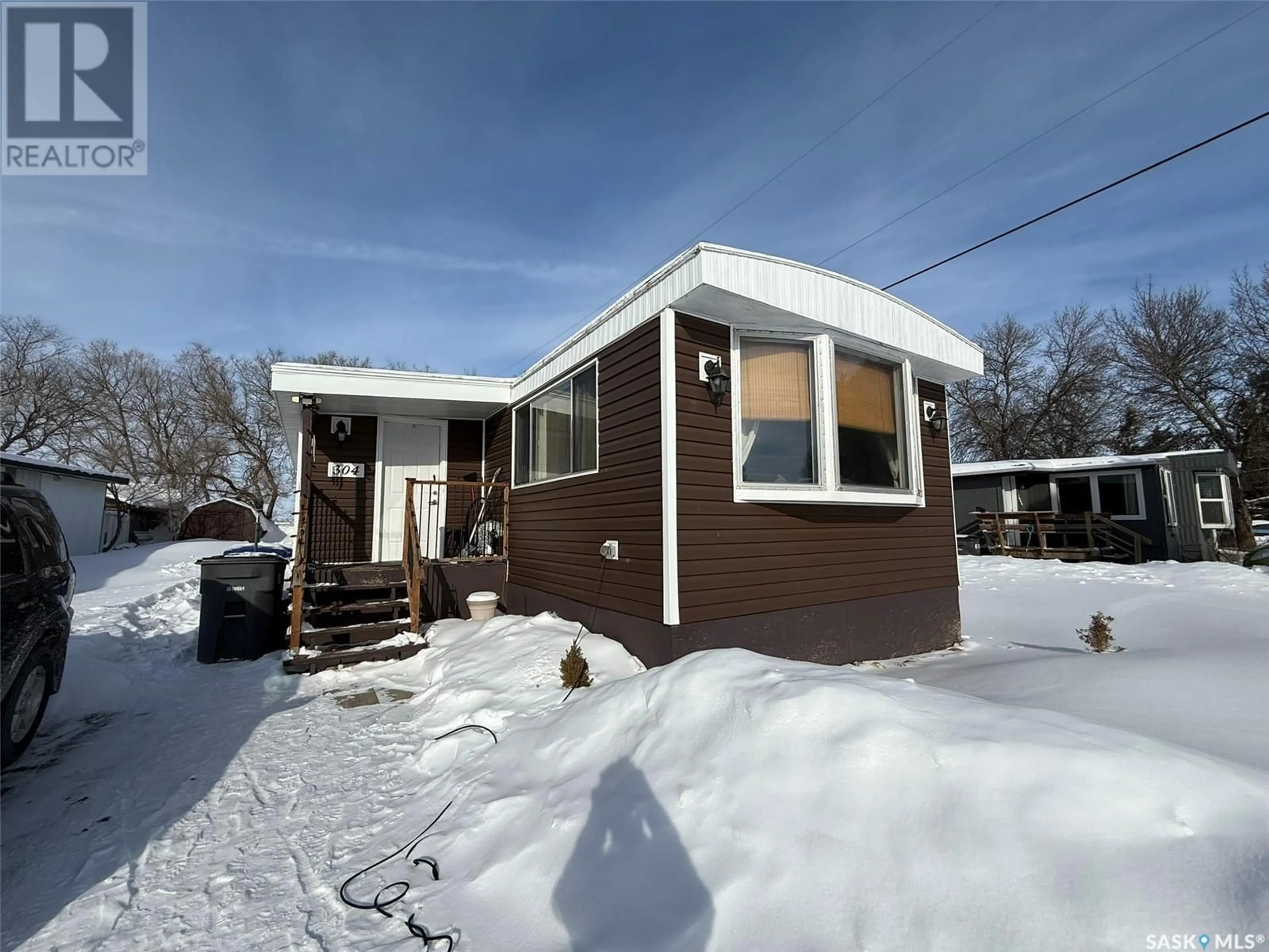 Home with vinyl exterior material, street for 304 5th AVENUE, Caronport Saskatchewan S0H0S0