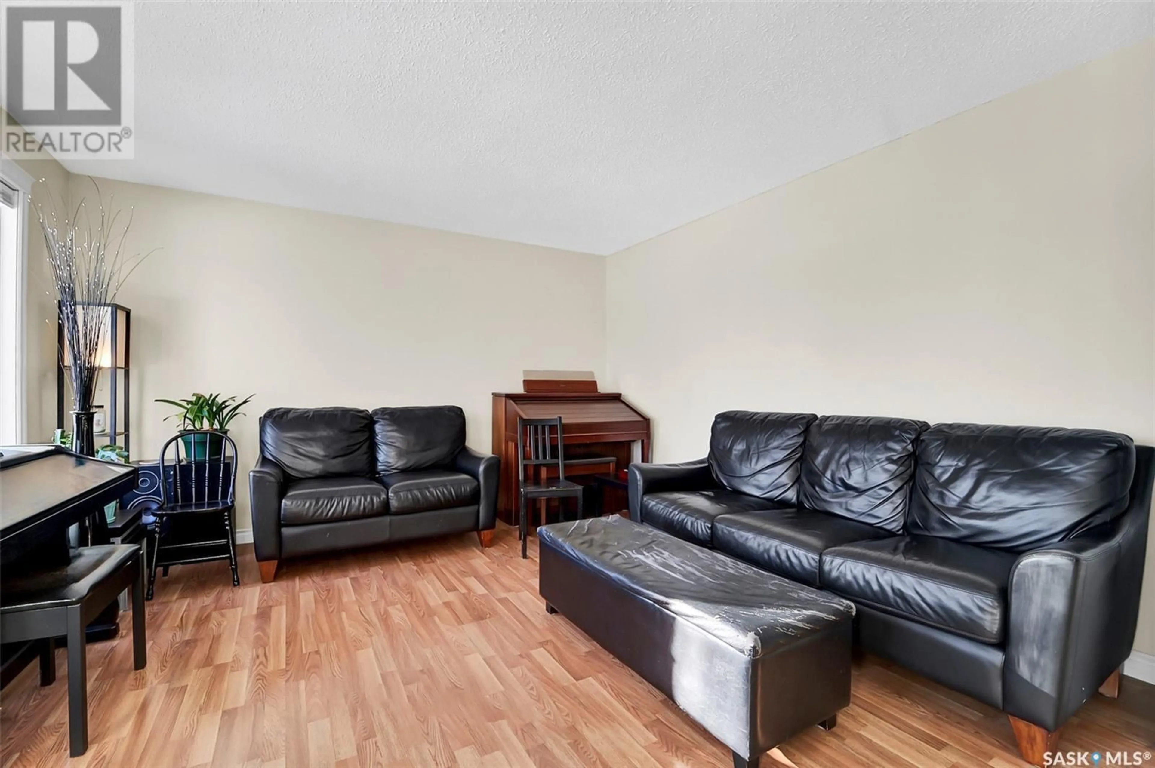 Living room with furniture, wood/laminate floor for 210 Molloy STREET, Saskatoon Saskatchewan S7K6N5