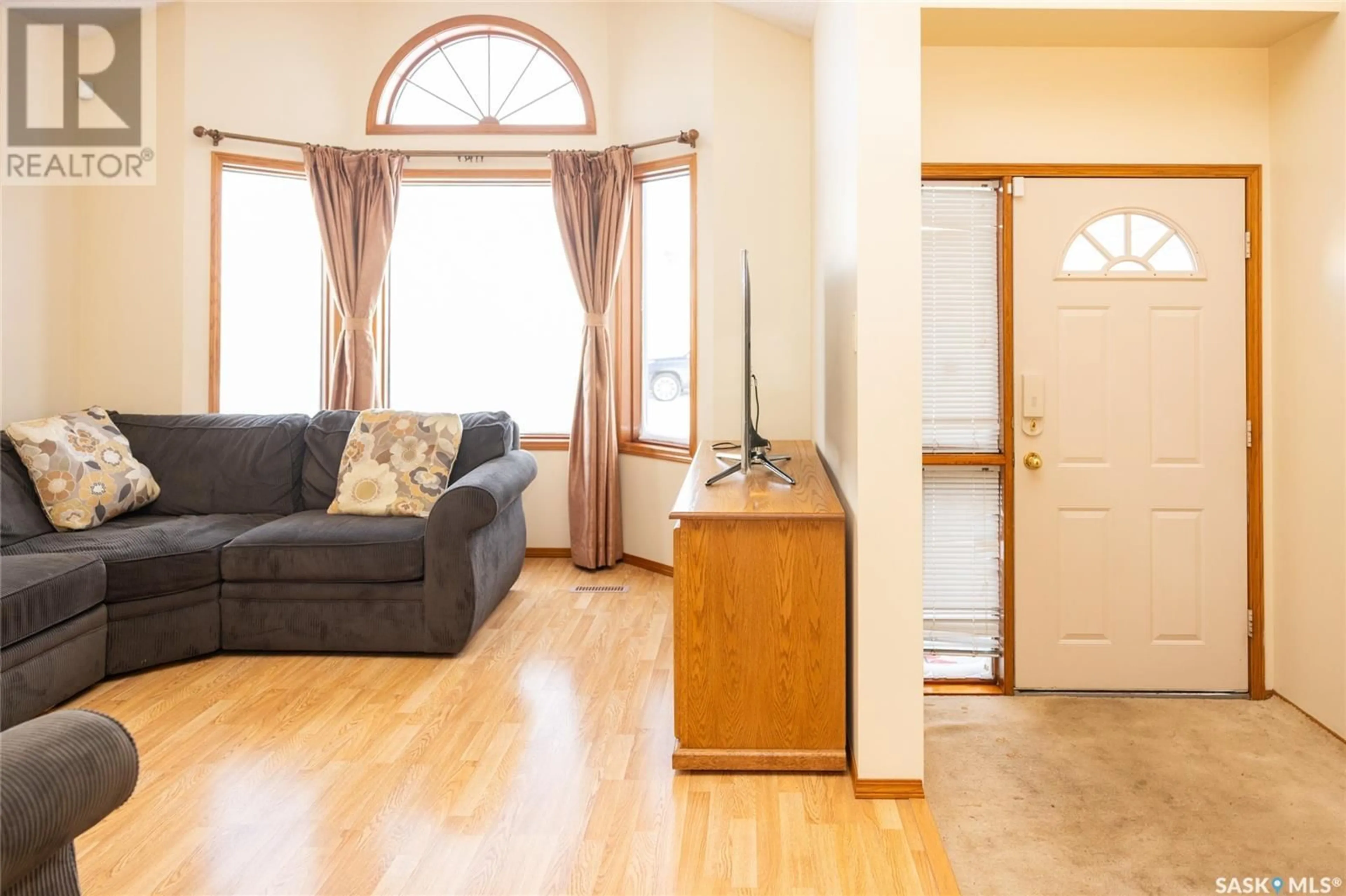 Living room with furniture, wood/laminate floor for 429 Swan LANE, Saskatoon Saskatchewan S7J5C1