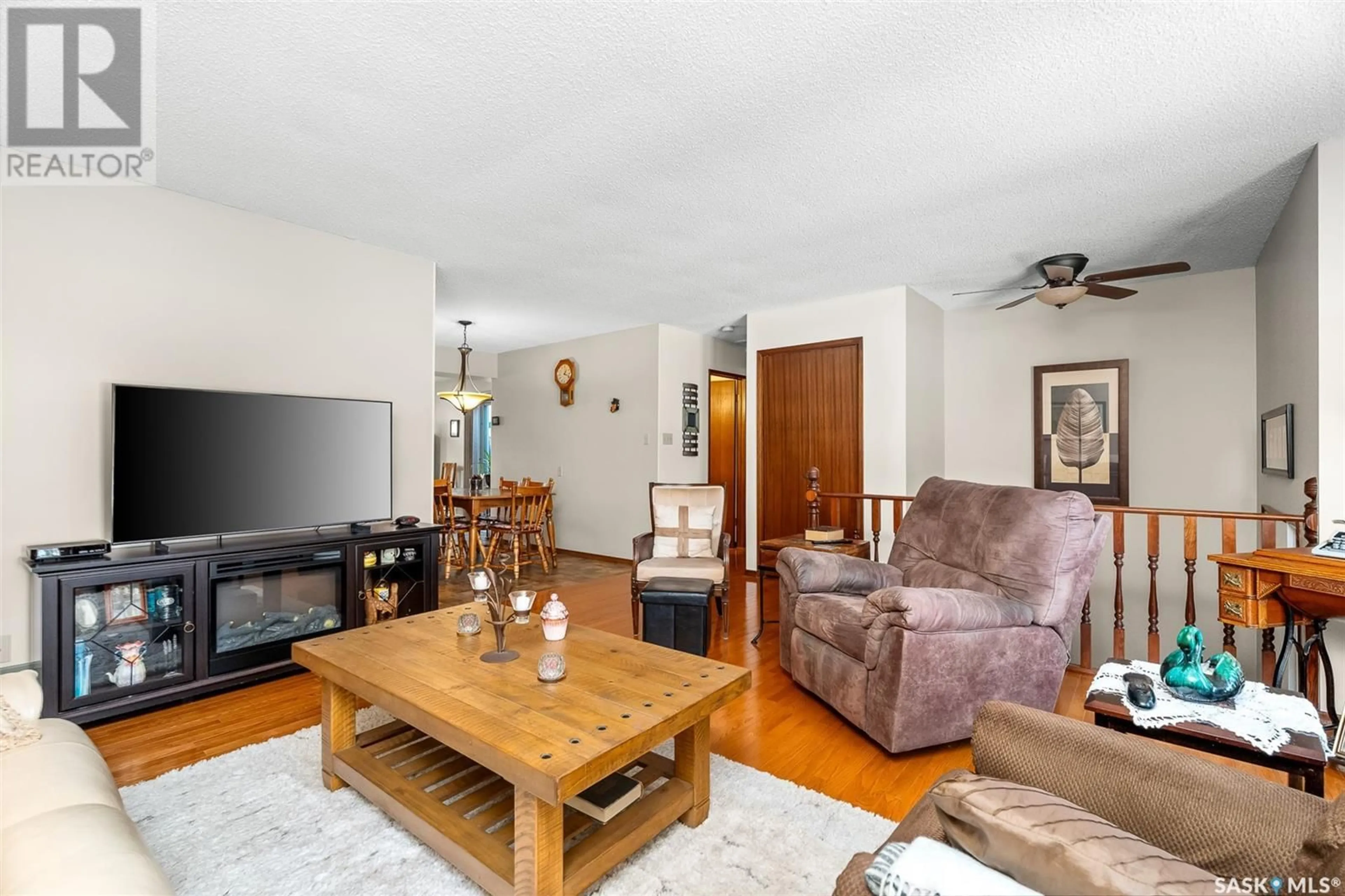 Living room with furniture, wood/laminate floor for 1012 Rorison AVENUE, Moose Jaw Saskatchewan S6H6W5