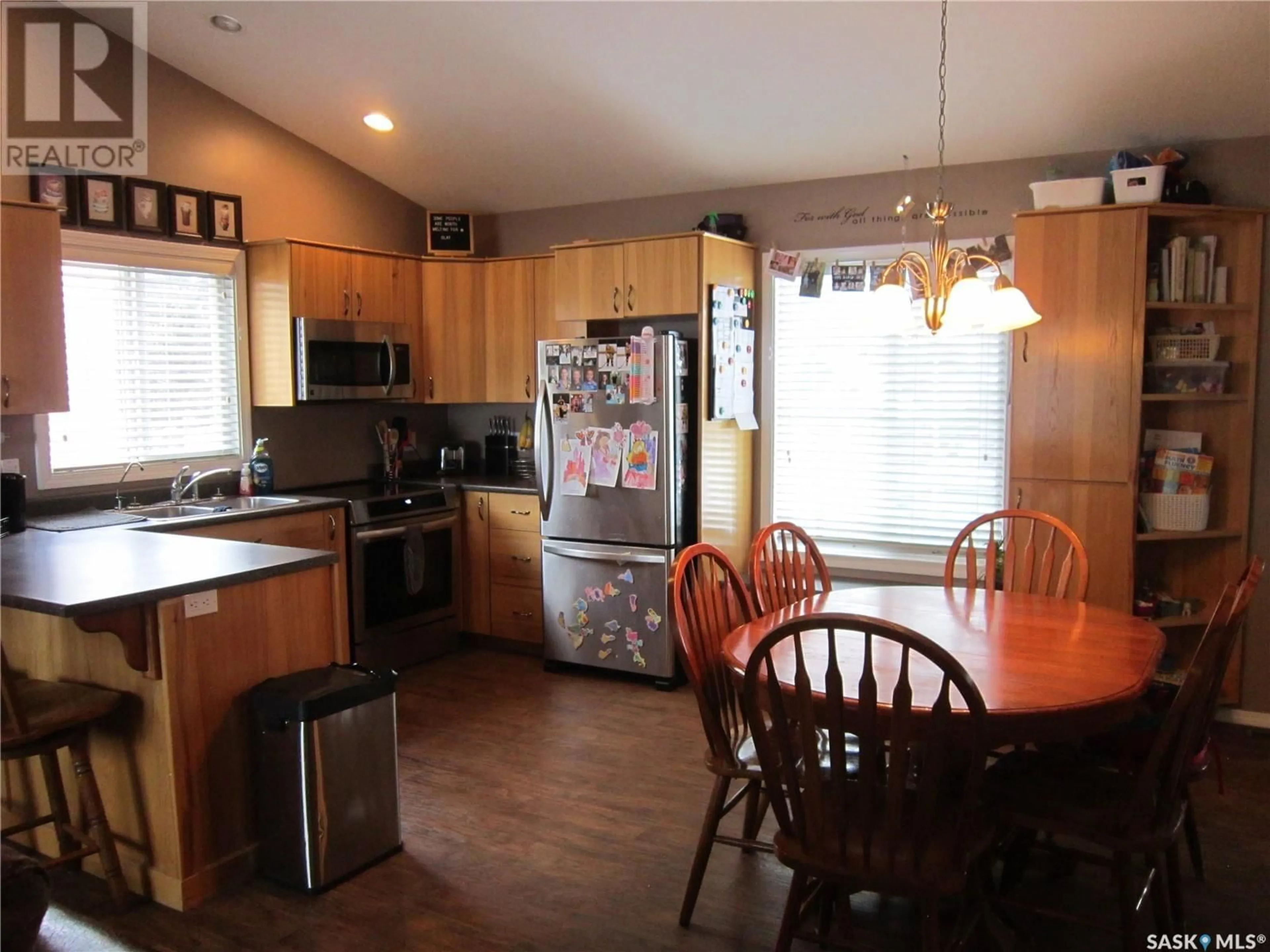 Open concept kitchen, wood/laminate floor for 335 RUTTLE AVENUE, Kinistino Saskatchewan S0J1H0