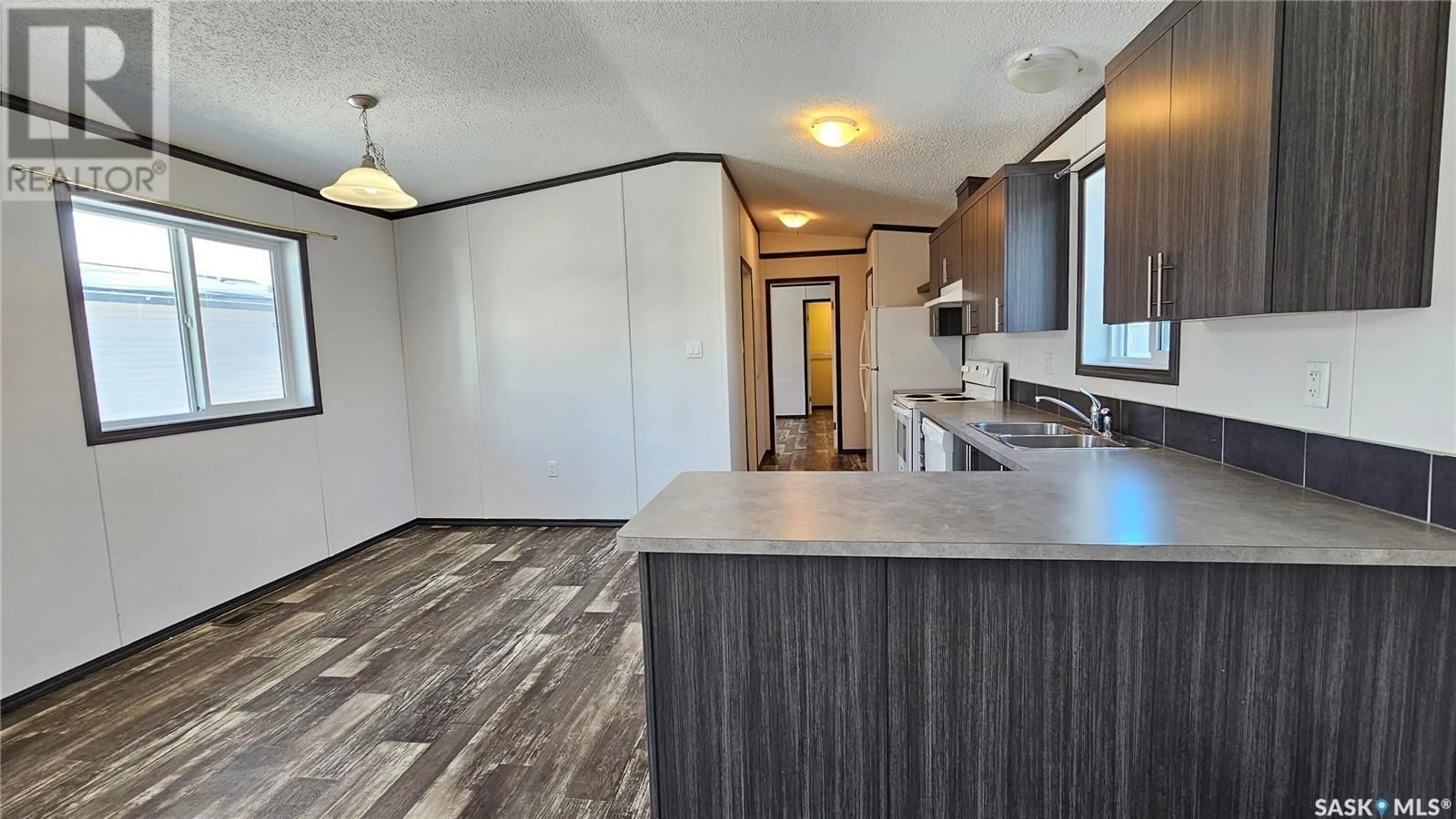 Open concept kitchen, wood/laminate floor for 21 Prairie Sun COURT, Swift Current Saskatchewan S9H3X6