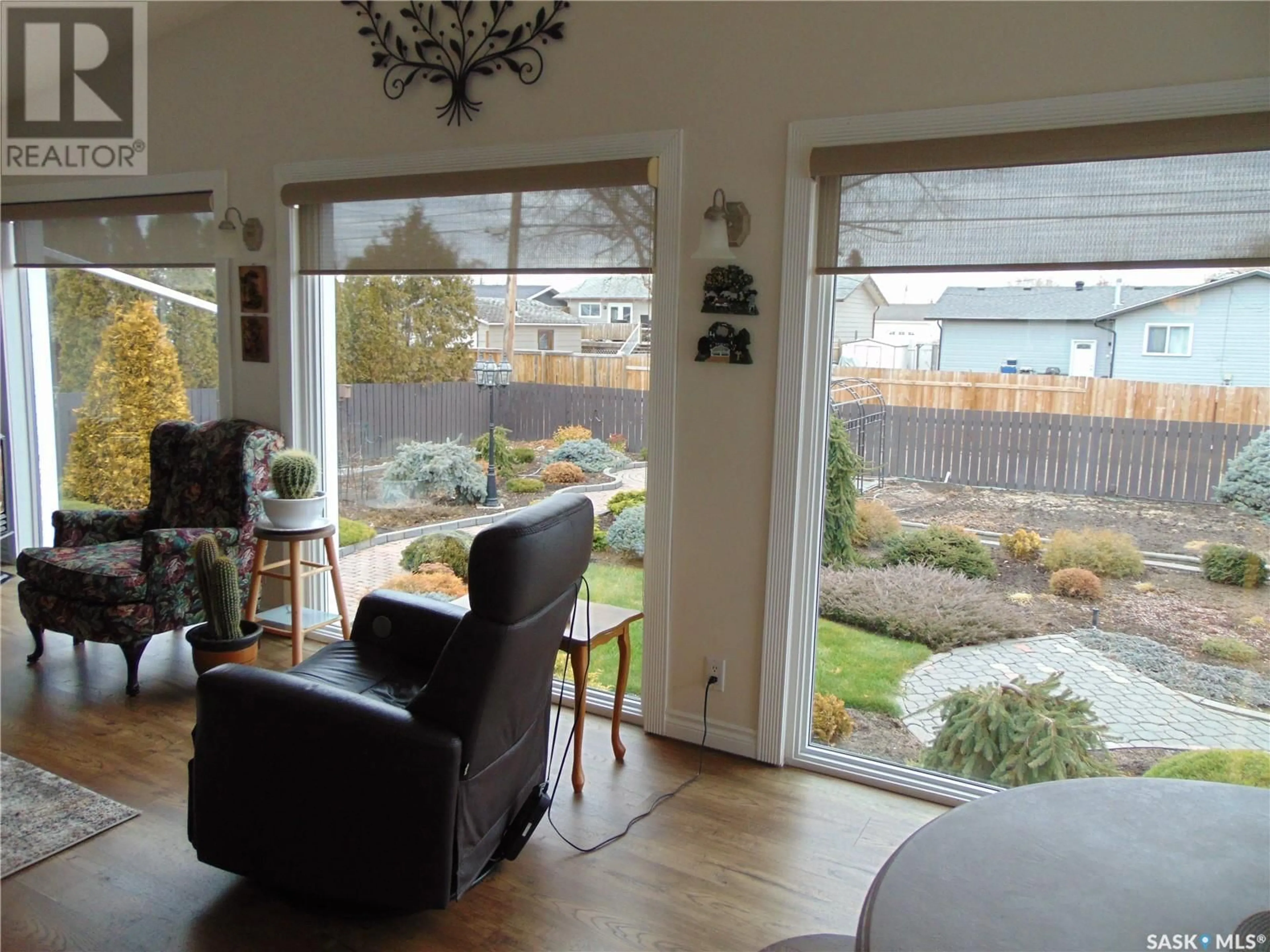 Living room with furniture, wood/laminate floor for 209 1st AVENUE N, Martensville Saskatchewan S0K2T0