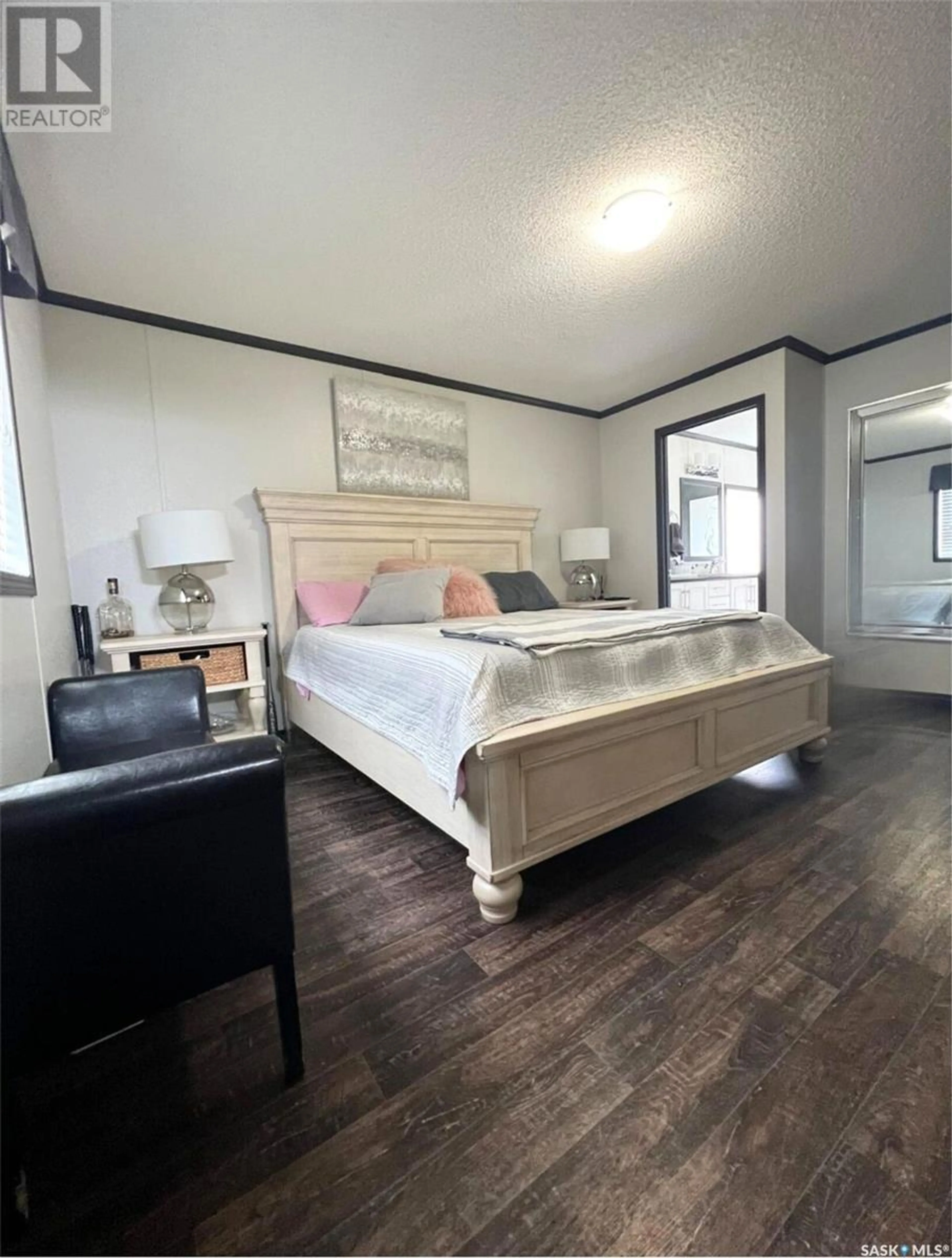 Bedroom with bed, wood/laminate floor for 190 Prairie Sun COURT, Swift Current Rm No. 137 Saskatchewan S9H3X6