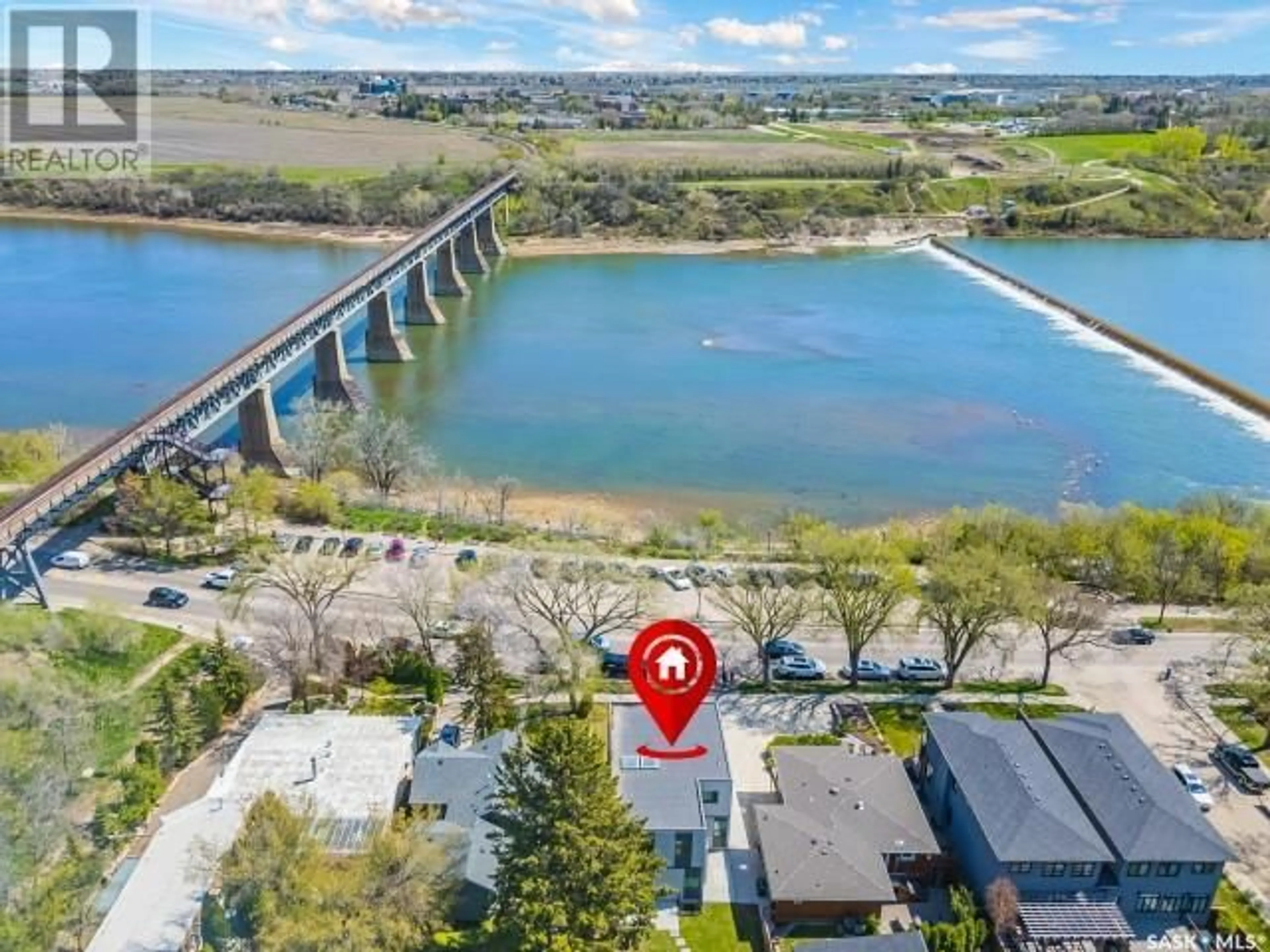 A pic from outside/outdoor area/front of a property/back of a property/a pic from drone, water/lake/river/ocean view for 1190 Spadina CRESCENT E, Saskatoon Saskatchewan S7K3H9