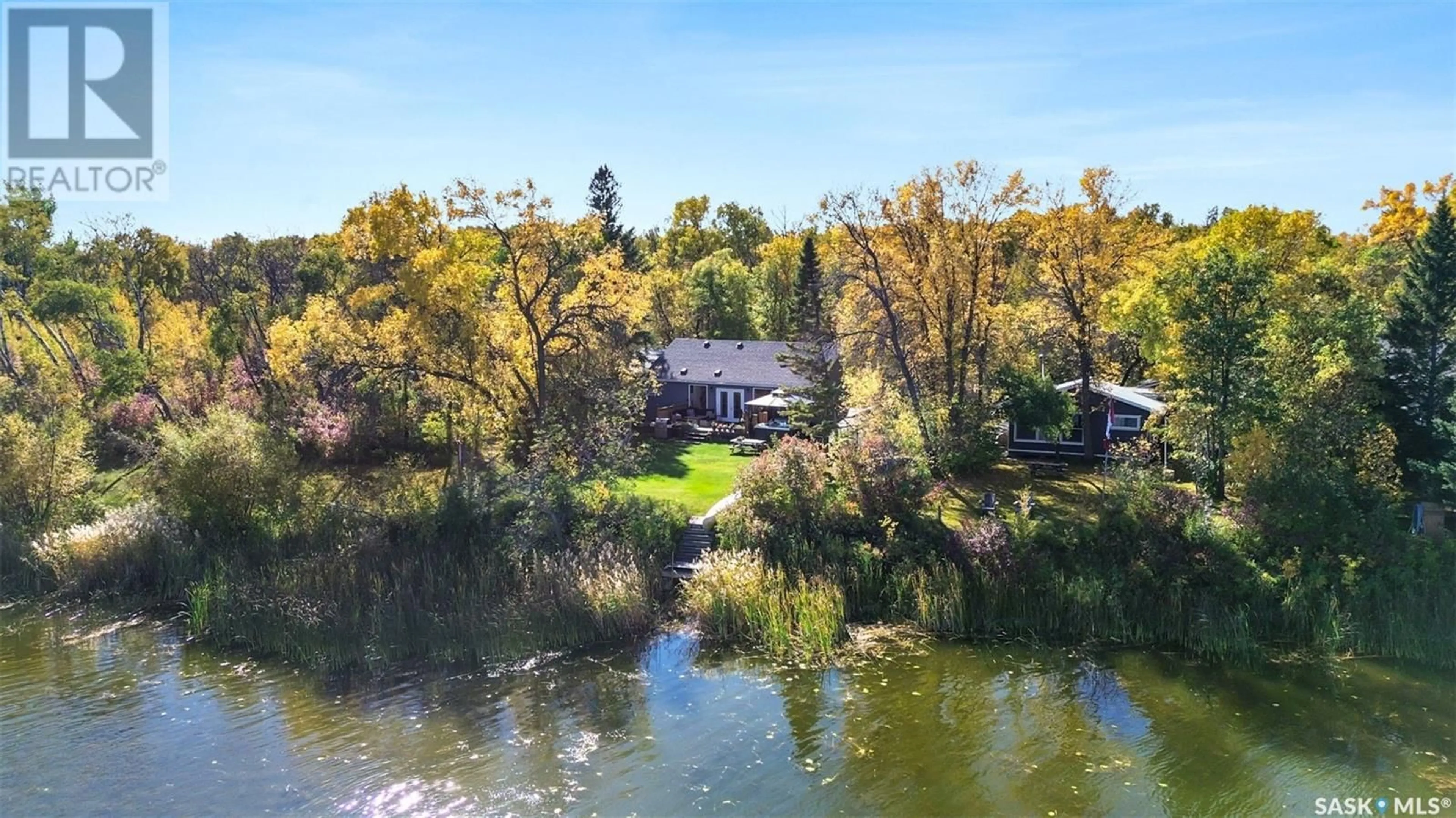 A pic from outside/outdoor area/front of a property/back of a property/a pic from drone, water/lake/river/ocean view for 115 Moosewoods AVENUE, Pike Lake Saskatchewan S7K1N2