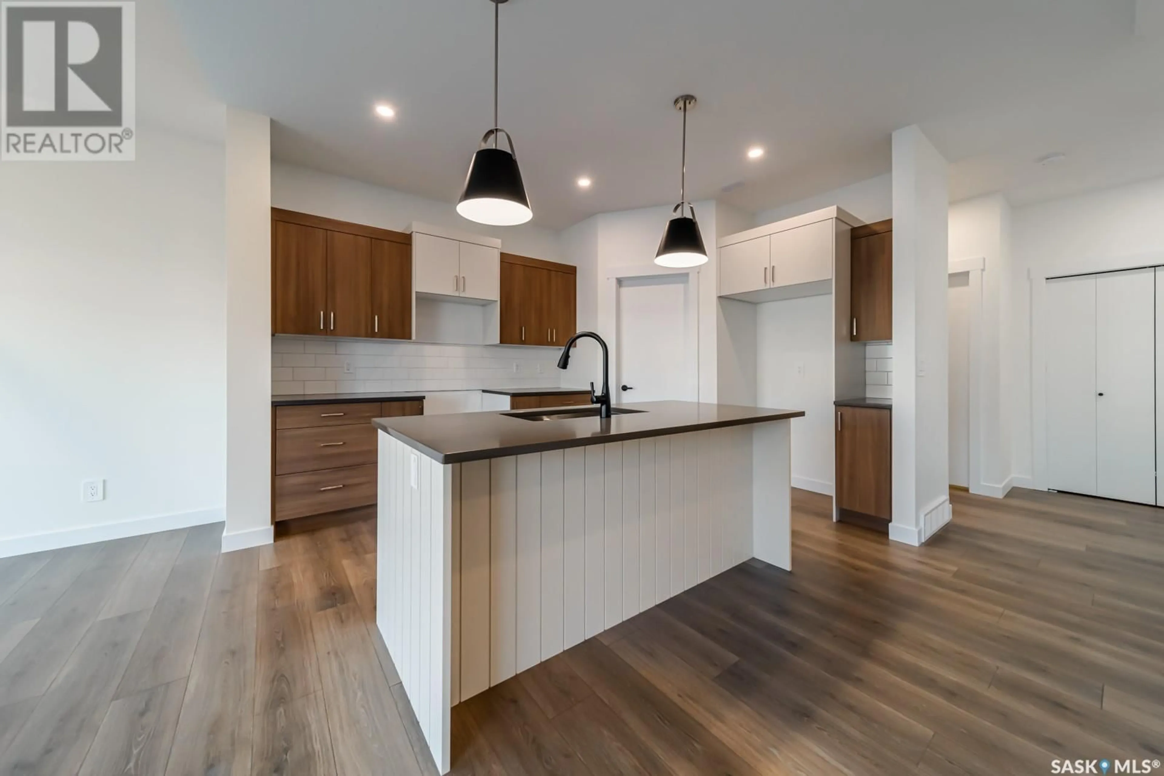 Open concept kitchen, wood/laminate floor for 499 DORAN CRESCENT, Saskatoon Saskatchewan S0K2T0