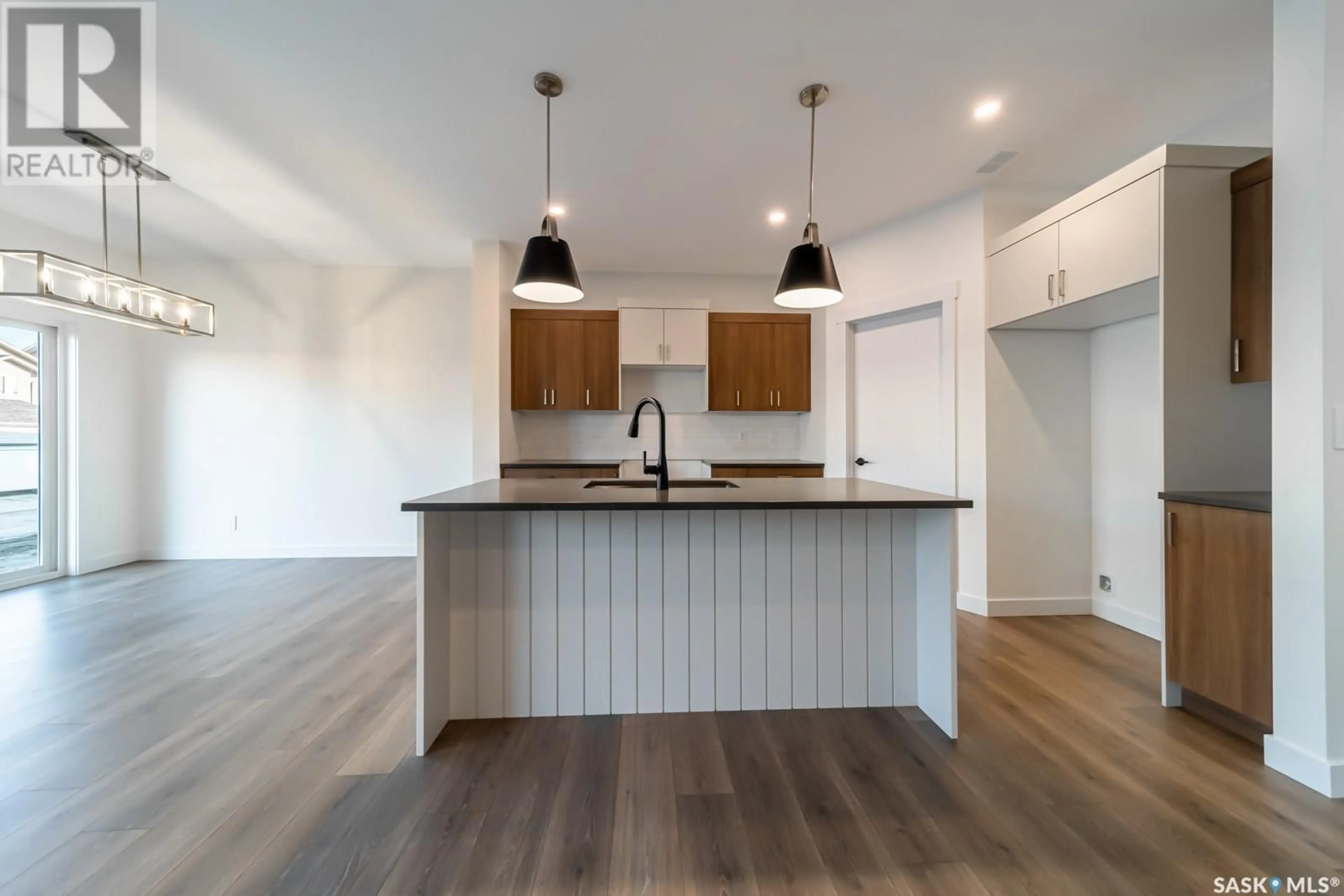 Open concept kitchen, wood/laminate floor for 499 DORAN CRESCENT, Saskatoon Saskatchewan S0K2T0