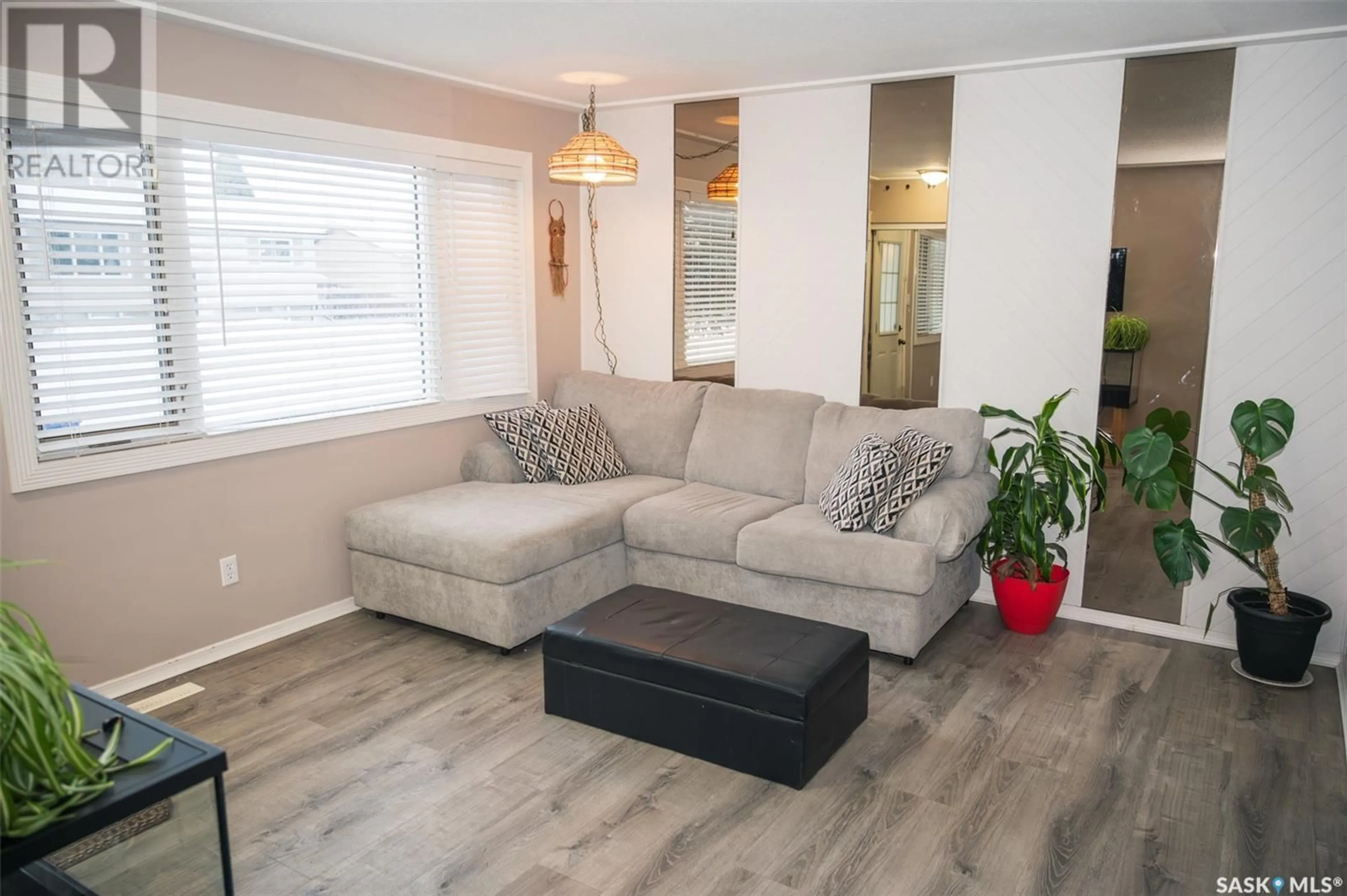 Living room with furniture, wood/laminate floor for 127 Ramsay COURT, Saskatoon Saskatchewan S7H4H3