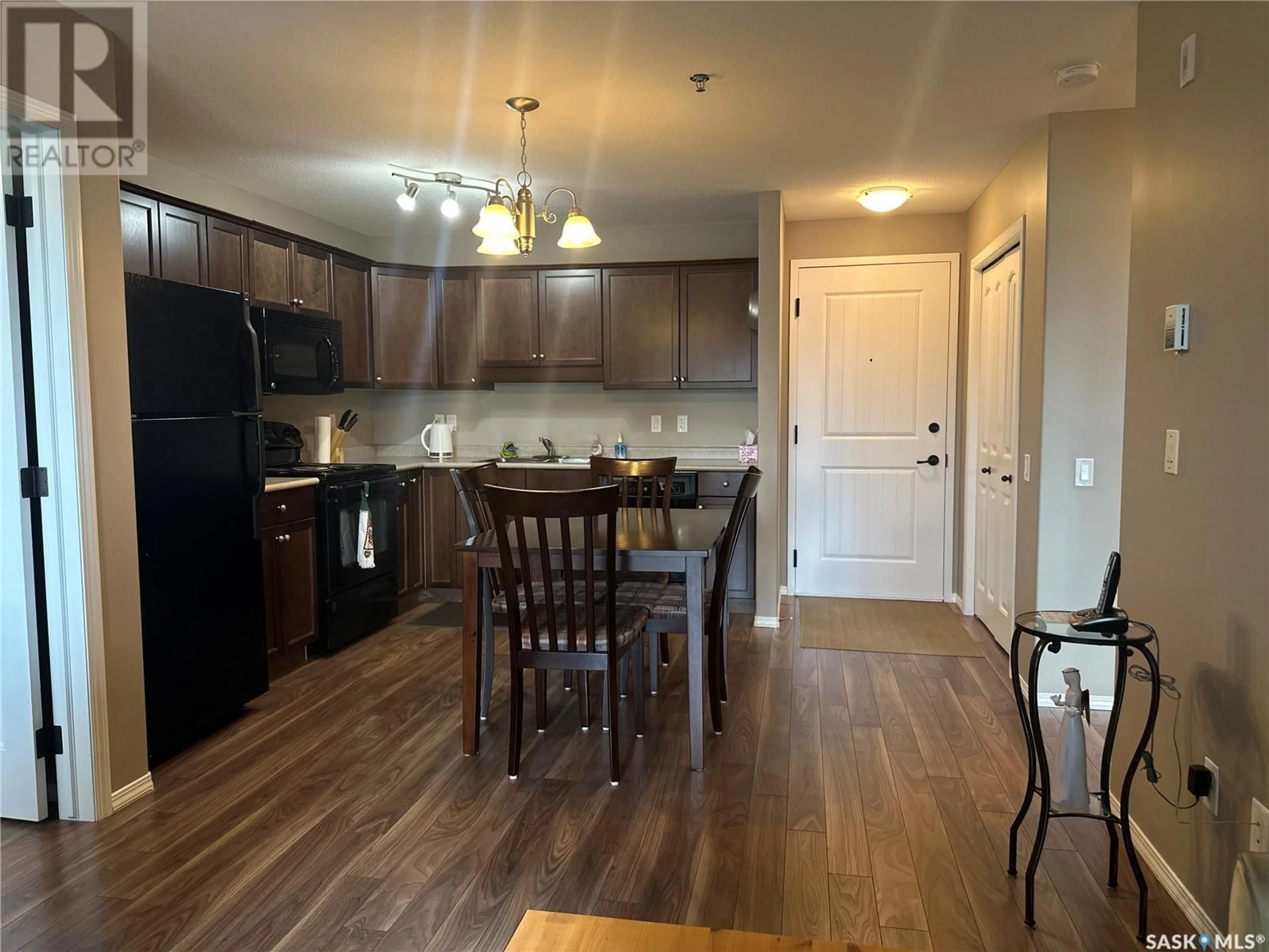 Open concept kitchen, wood/laminate floor for 202E 1300 Stockton STREET N, Regina Saskatchewan S4X0G1