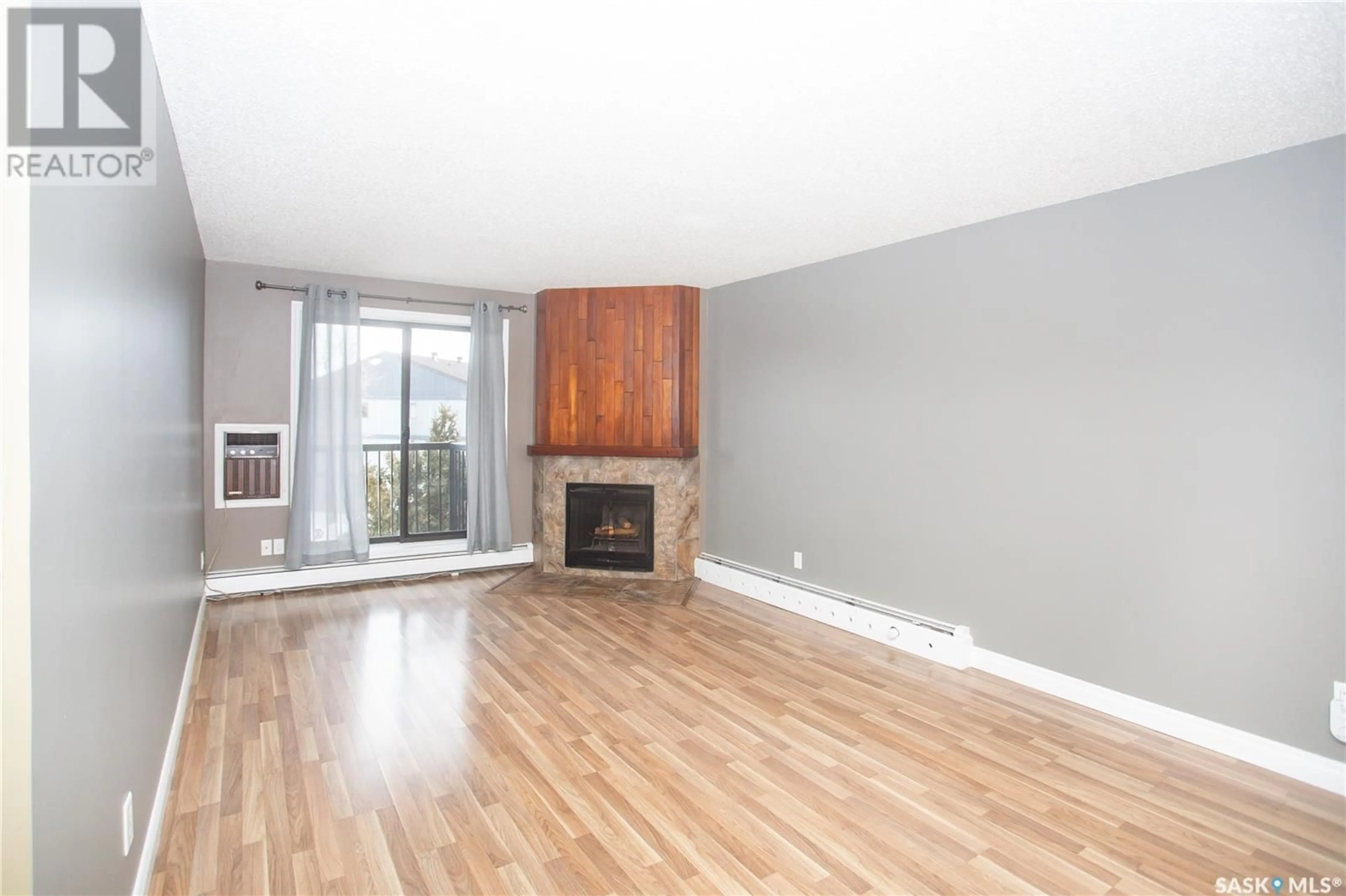 Living room with furniture, wood/laminate floor for 301 802B Kingsmere BOULEVARD, Saskatoon Saskatchewan S7J4B7