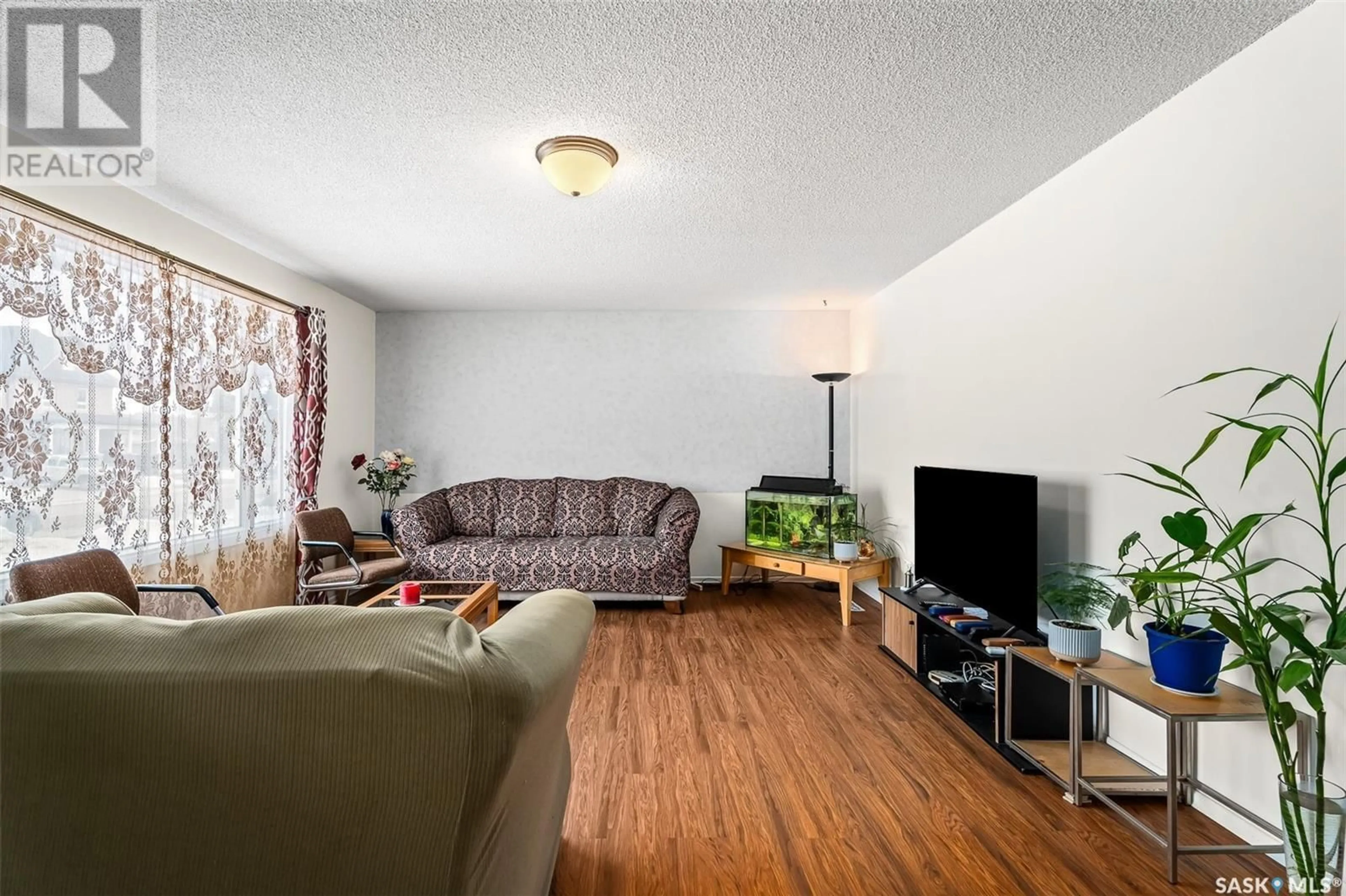 Living room with furniture, wood/laminate floor for 429 Athabasca STREET W, Moose Jaw Saskatchewan S6H2C4