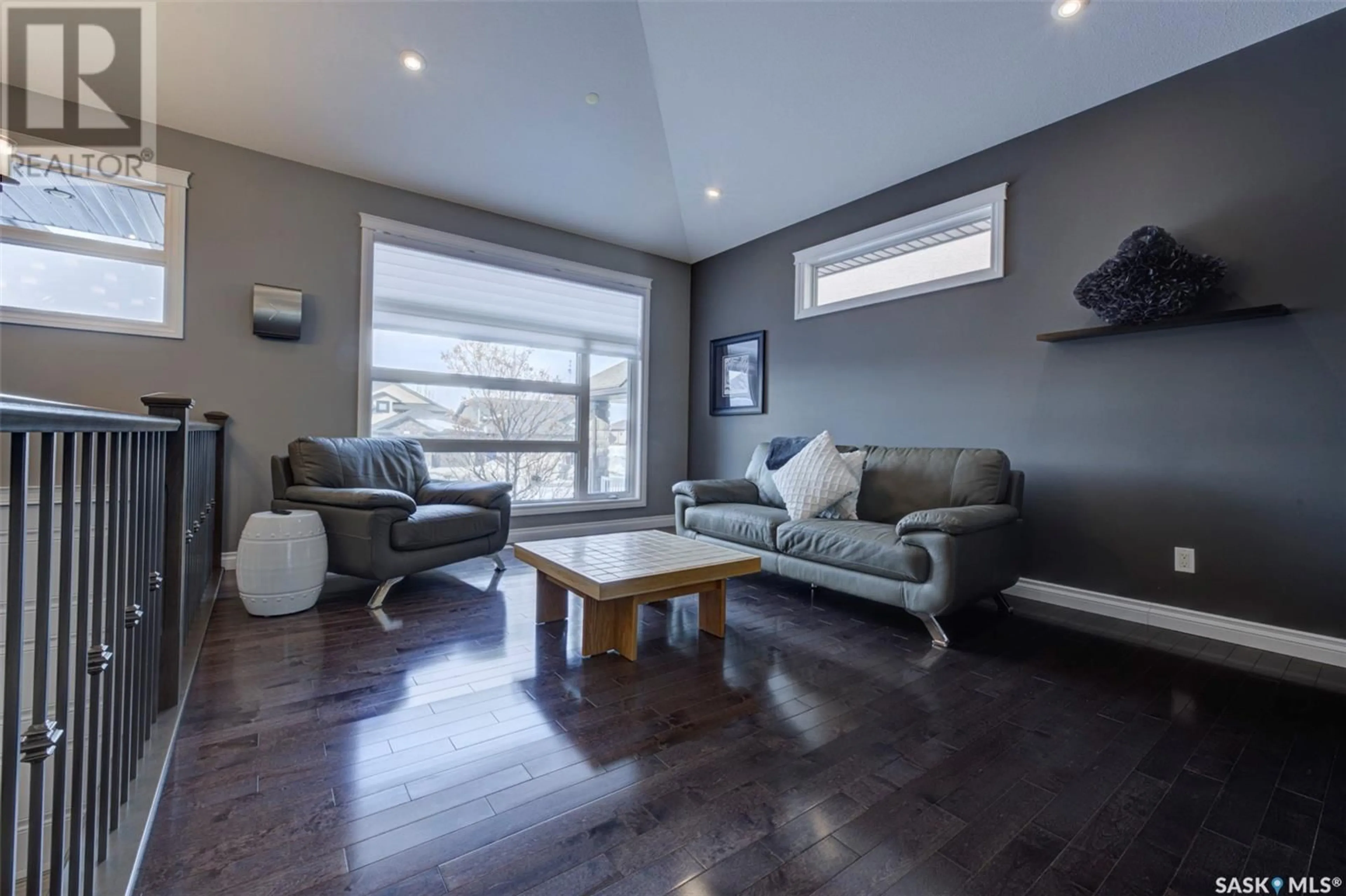 Living room with furniture, wood/laminate floor for 212 AUGUSTA DRIVE, Warman Saskatchewan S0K4S1