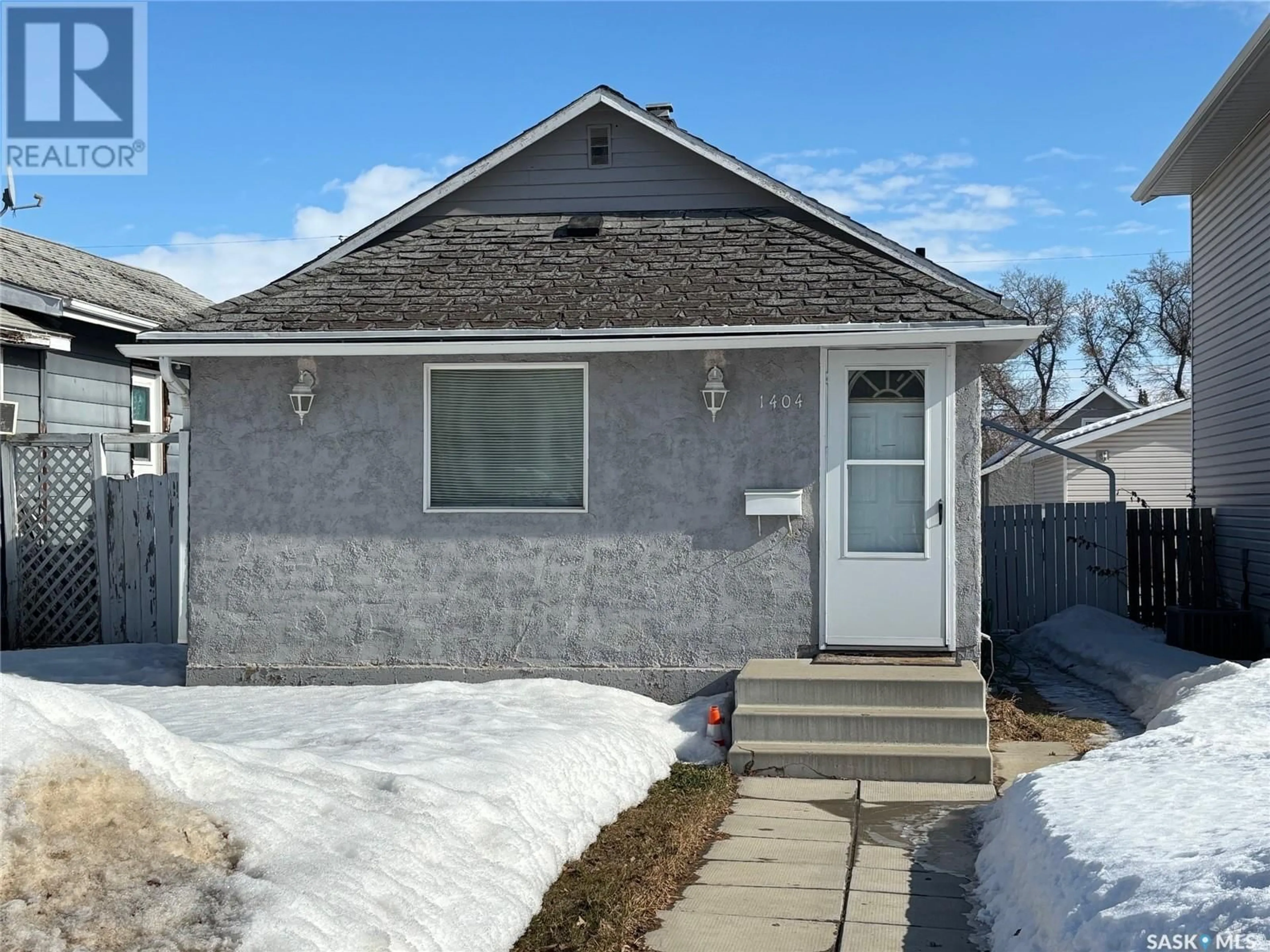 Home with vinyl exterior material, street for 1404 6TH AVENUE N, Saskatoon Saskatchewan S7K2T8