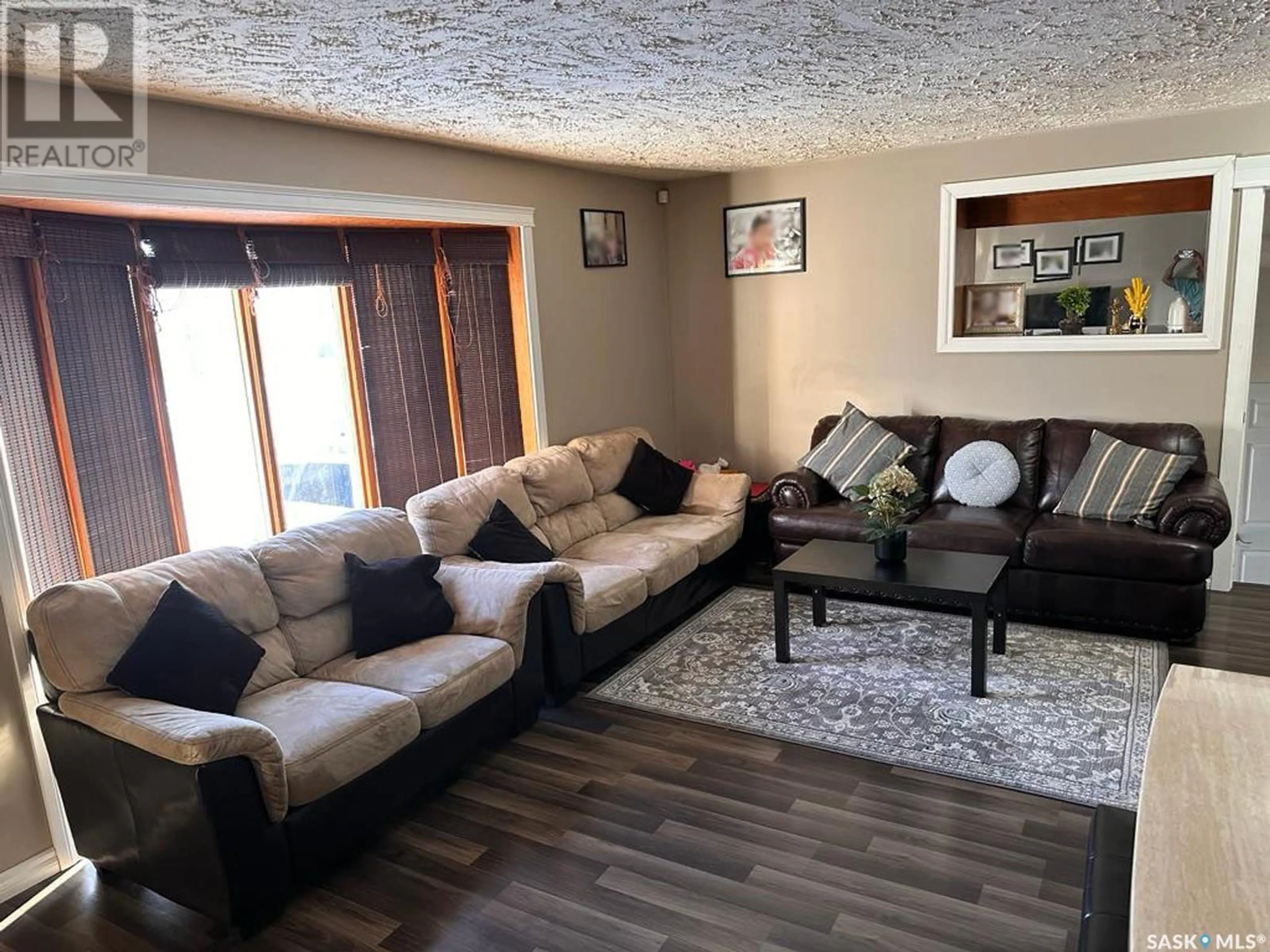 Living room with furniture, wood/laminate floor for 609 2ND STREET, Meadow Lake Saskatchewan S9X1Y9